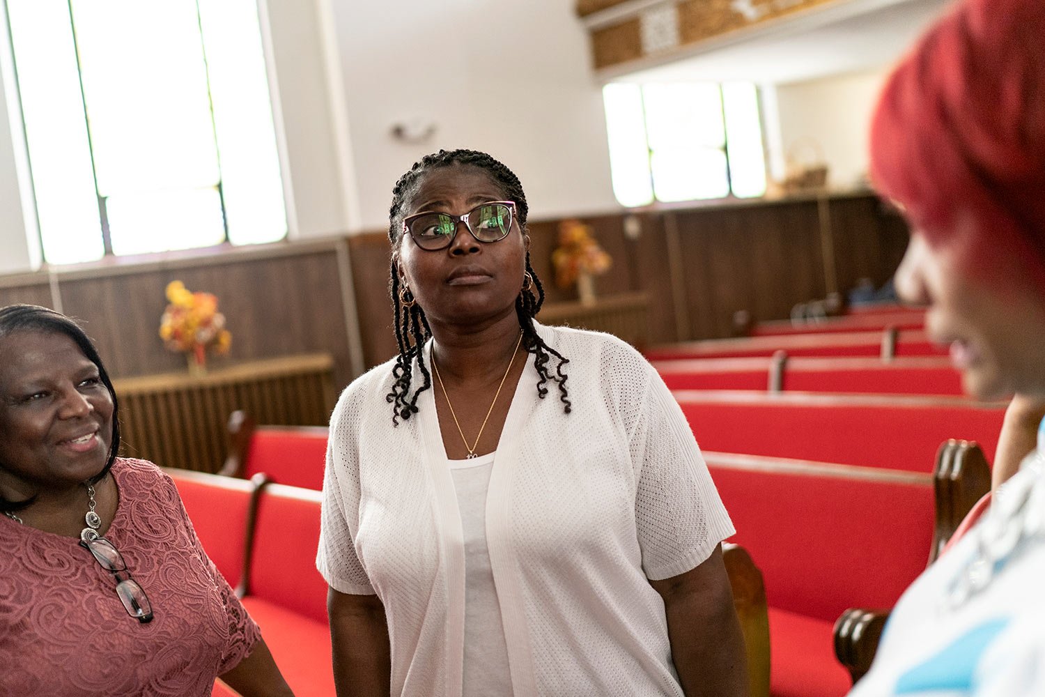  Tameka Felts, center, a church trustee who also is licensed to carry a gun, talks with congregants following a service at Trinity Baptist church Sunday, Aug. 20, 2023, in Niagara Falls, N.Y. (AP Photo/David Goldman)  