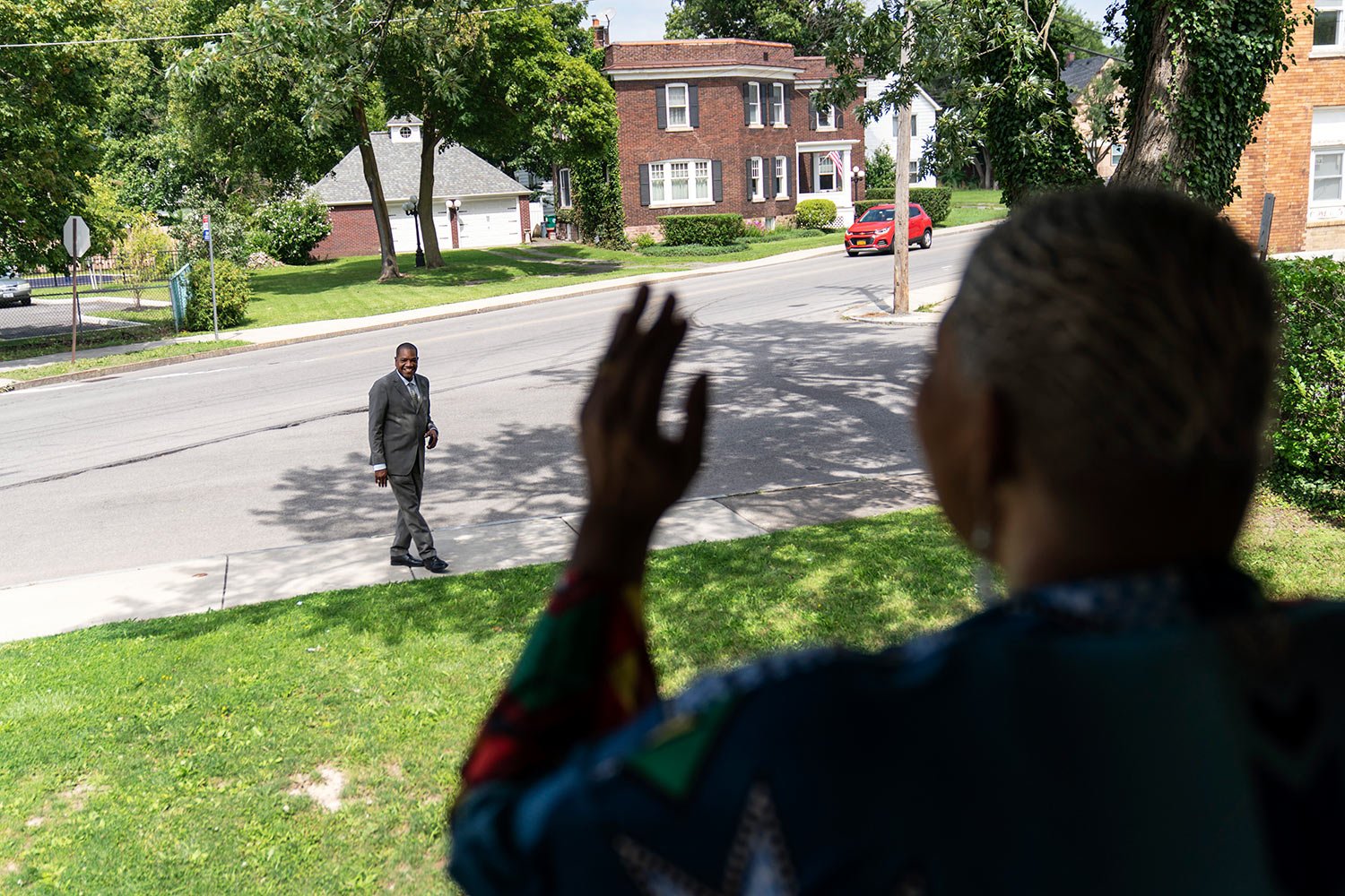  Trinity Baptist’s Rev. Jimmie Hardaway Jr., rear, smiles as he’s sang to by Marsha McWilson outside her home, Sunday, Aug. 20, 2023, in Niagara Falls, N.Y. (AP Photo/David Goldman)  