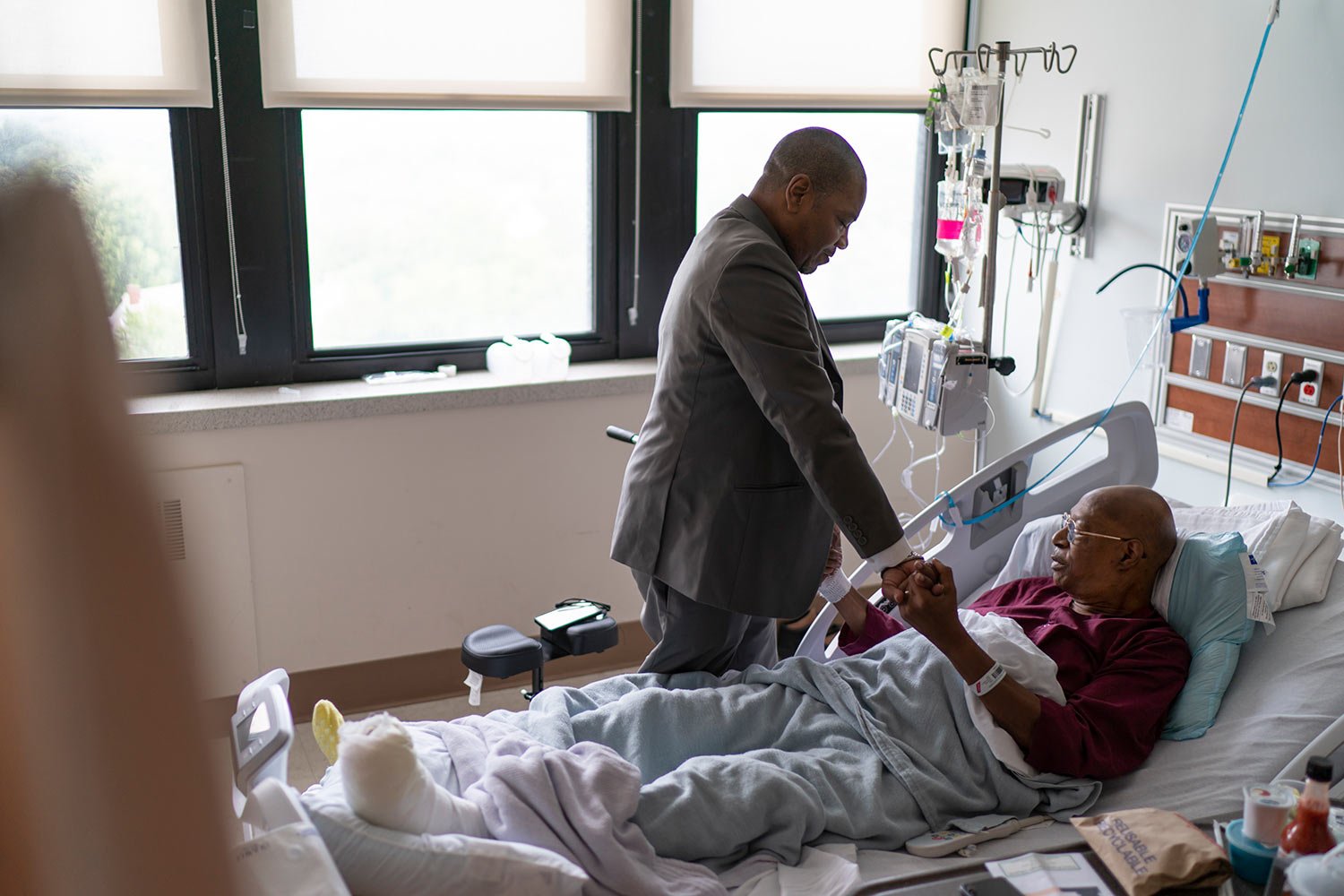  Rev. Jimmie Hardaway Jr., left, prays with, Rev. Charles Searcy, while visiting friends recovering in a hospital, Sunday, Aug. 20, 2023, in Buffalo, N.Y. (AP Photo/David Goldman)  