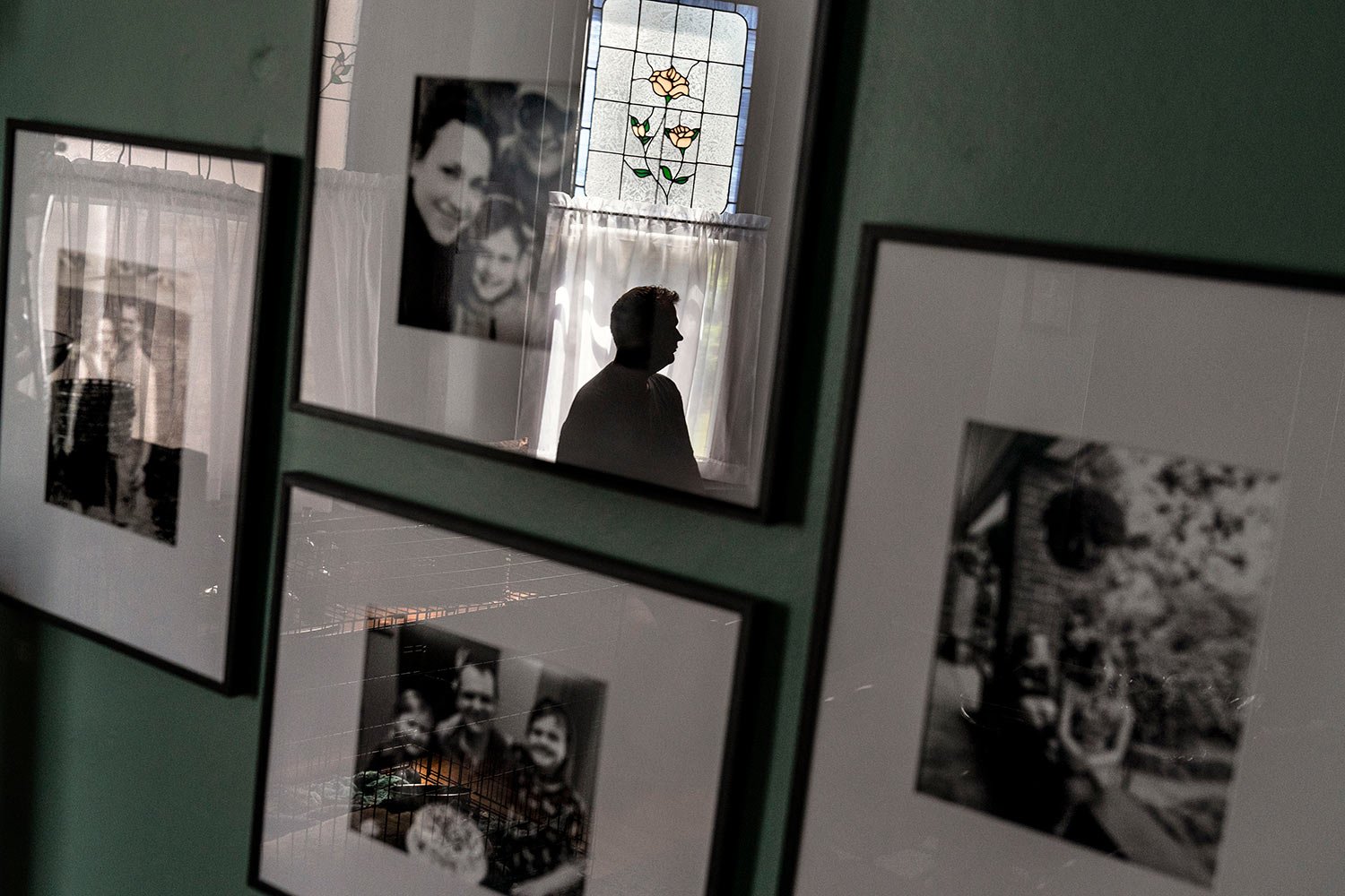  Family photos hang in the home as Hollan Holm, sits for a portrait, in Louisville, Ky., Sunday, June 4, 2023. (AP Photo/David Goldman)  