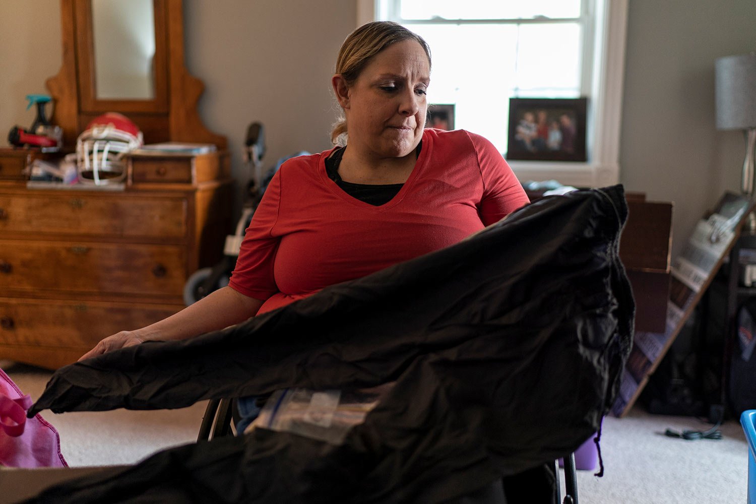  Missy Jenkins Smith looks at the pants she was wearing when she was shot as a student at Heath High School in 1997 as she and her family prepare to move from their home in Murray, Ky., Monday, June 5, 2023. One of shooter’s bullets paralyzed her fro