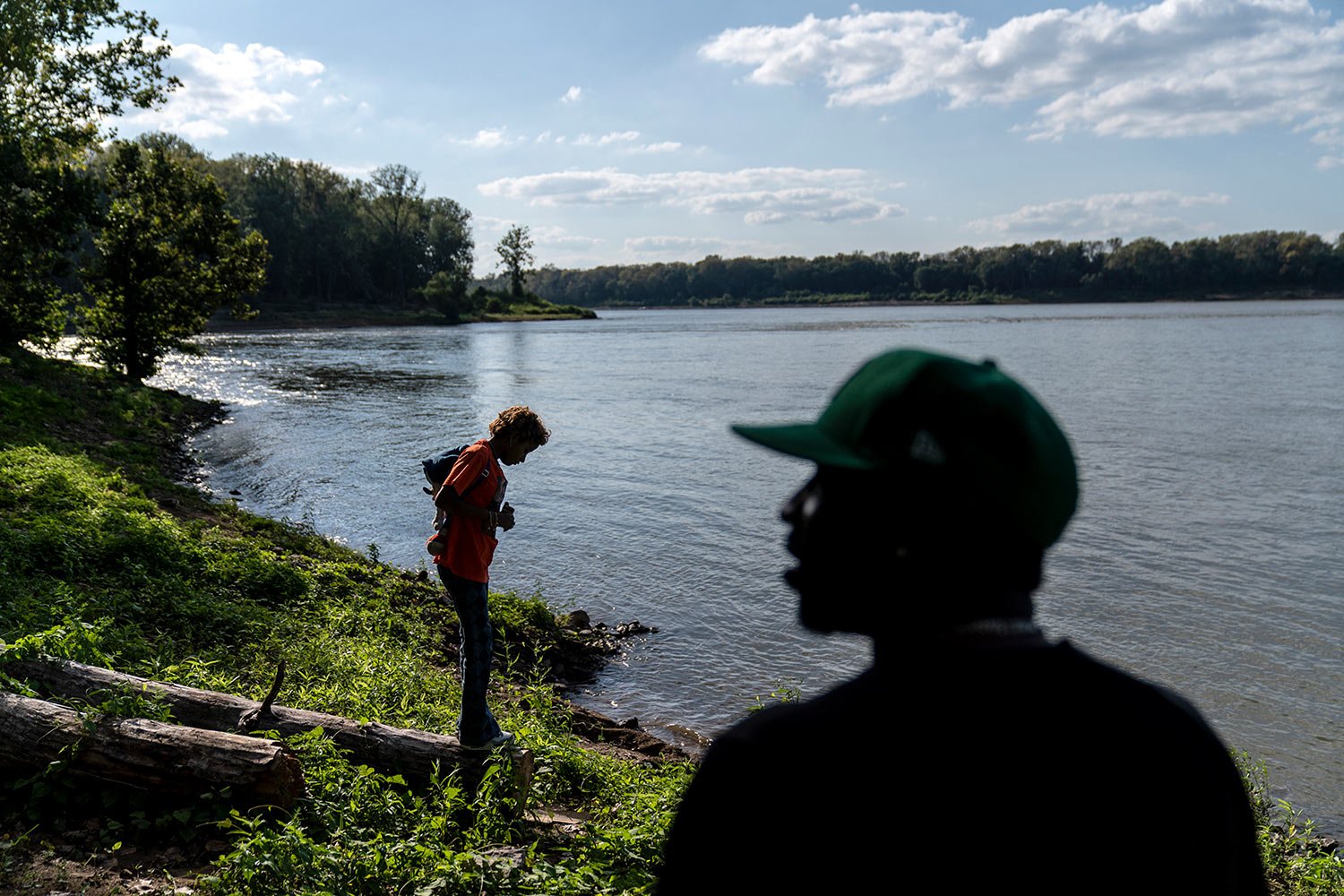  Navada, Gwynn, right, visits the spot along the Ohio River where he used to fish with his son, Christian, in Louisville, Ky., Monday, Aug. 28, 2023, as his daughter, also named Navada, 15, stands at the water’s edge. (AP Photo/David Goldman)  