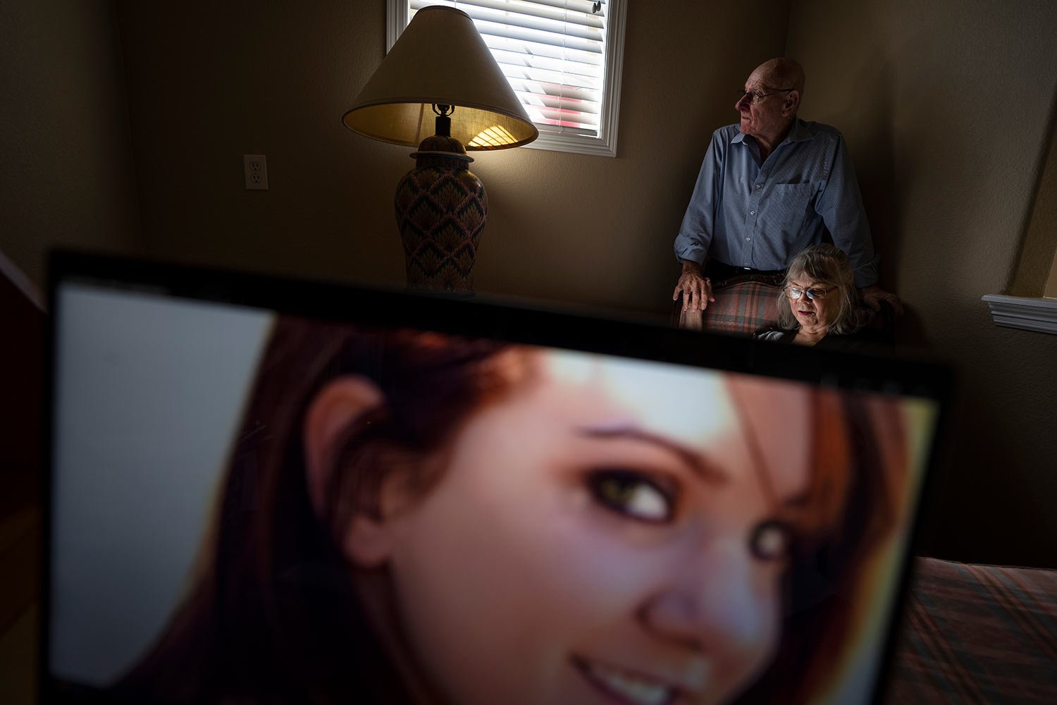  Sandy Phillips, right, sits for a portrait at her friend’s home in Lone Tree, Colo., Tuesday, Sept. 5, 2023, with her husband, Lonnie, behind a photo of her daughter, Jessica Ghawi, who was killed in the 2012 mass shooting at an Aurora, Colorado mov