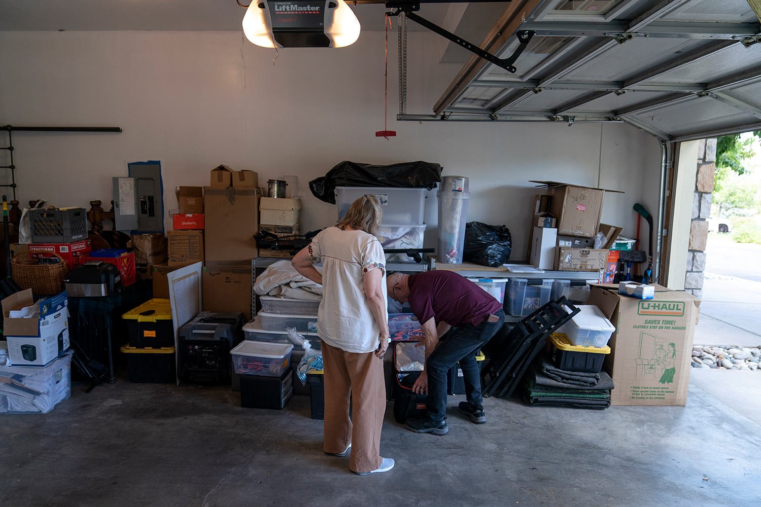  Lonnie, right, and Sandy Phillips, sift through their belongings stored at a friend’s garage in Lone Tree, Colo., Monday, Sept. 4, 2023. (AP Photo/David Goldman)  