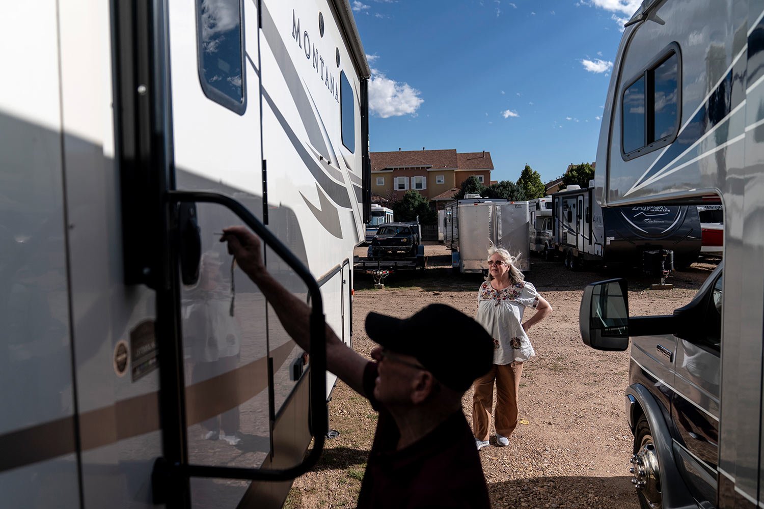  Lonnie Phillips, left, opens up the RV he and his wife, Sandy, right, used to travel from one mass shooting to another, as it sits in a storage lot in Longmont, Colo., Monday, Sept. 4, 2023. (AP Photo/David Goldman)  