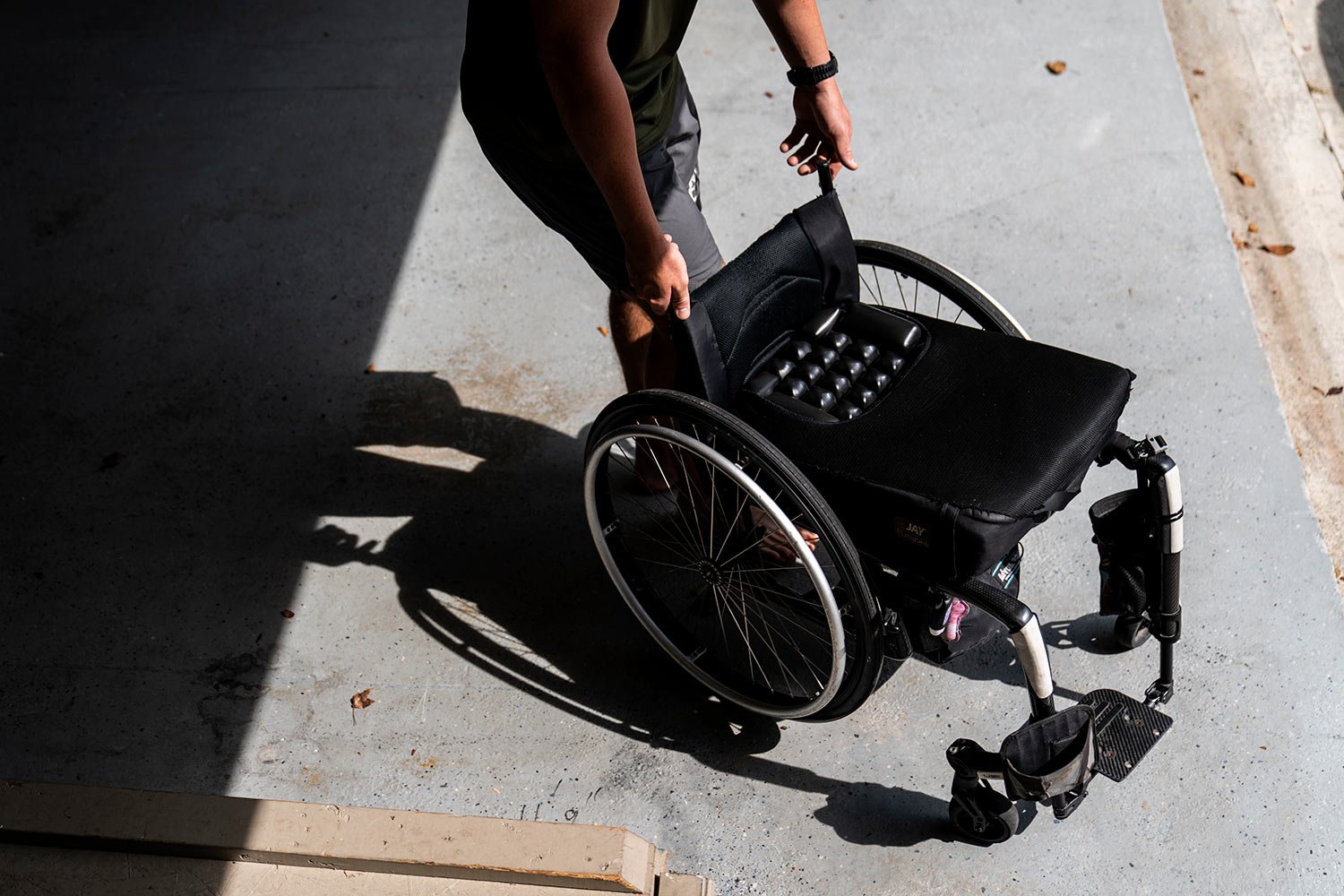  Hunter Paulsen, 20, pushes out a wheelchair from the garage for his mother, Janet, at their home in Acworth, Ga., Monday, Aug. 7, 2023. (AP Photo/David Goldman)  