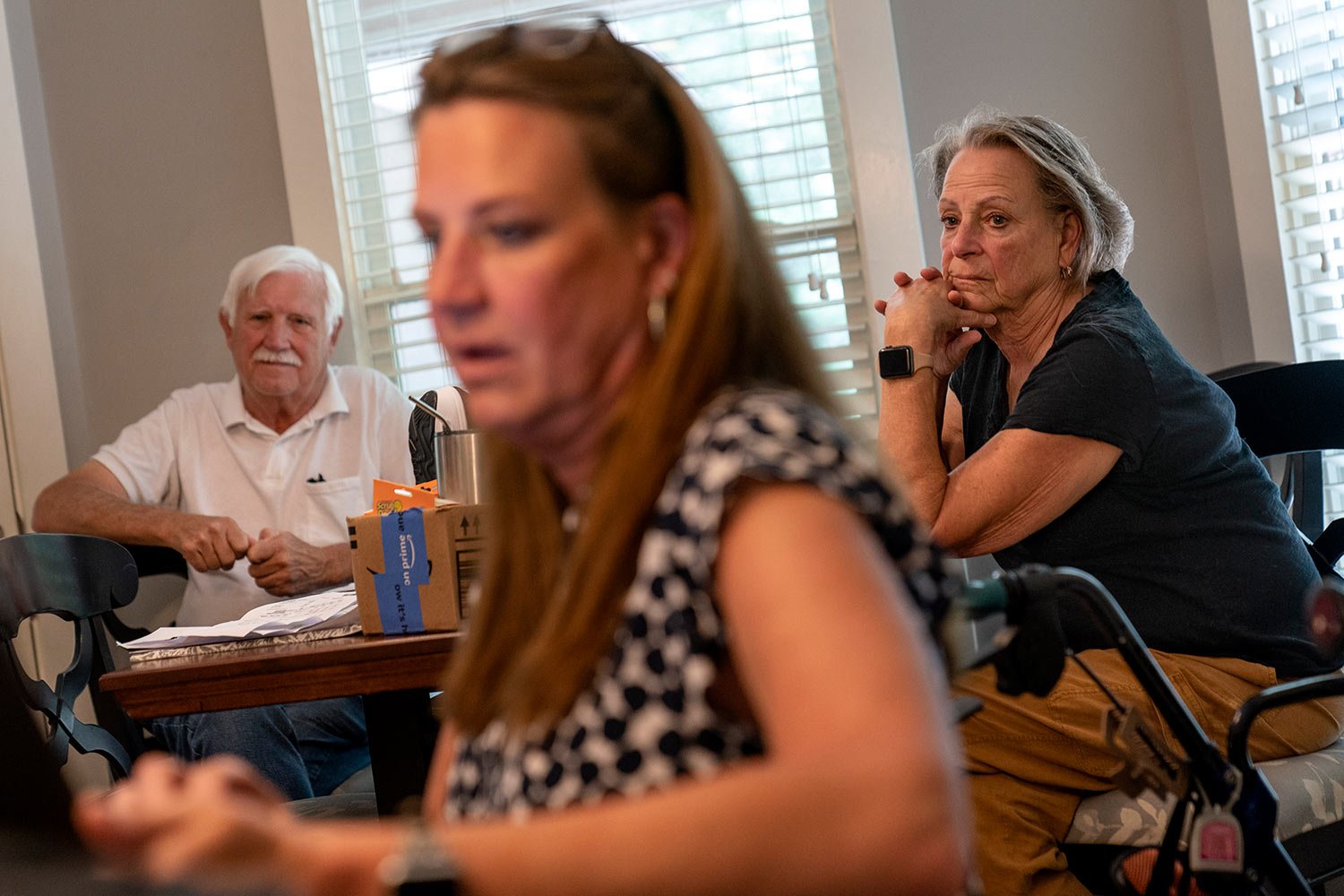  Ralph, left, and Deb Paulsen, the father and mother of Janet Paulsen, center, look on as she sits in her kitchen in Acworth, Ga., Monday, Aug. 7, 2023. (AP Photo/David Goldman)  