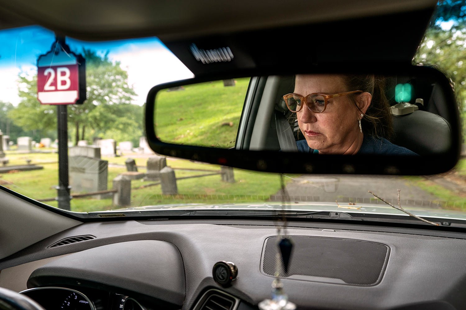  Janet Paulsen drives through the cemetery in Acworth, Ga., Tuesday, Aug. 8, 2023, where her estranged husband used to park with their twin sons in their car seats and drink before bringing them home. (AP Photo/David Goldman)  