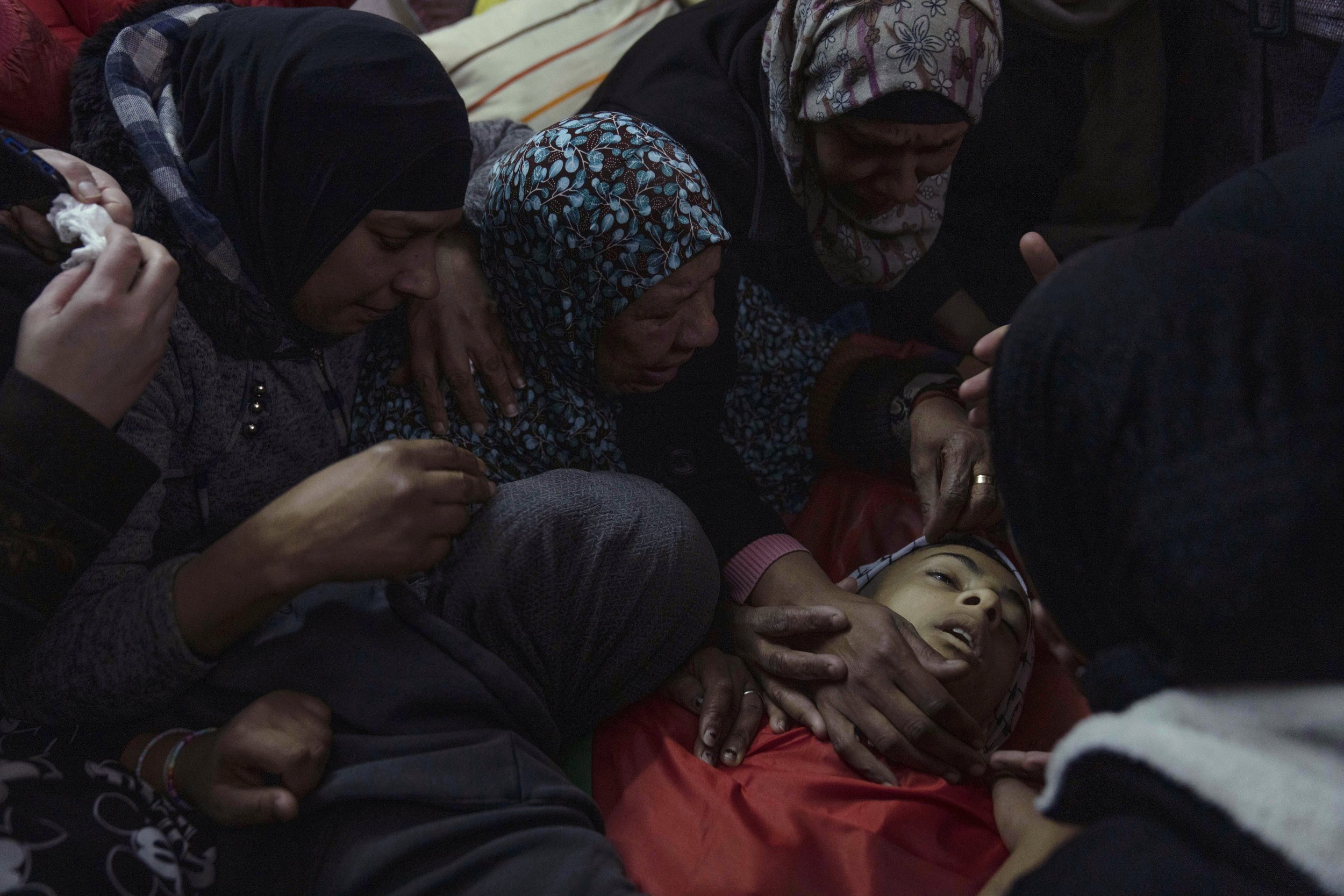  Mourners take a last look at the body of Palestinian Amer Abu Zeitoun, 16, at the family house during his funeral in the West Bank refugee camp of Balata, Nablus, on Jan. 5, 2023. Abu Zeitoun was killed earlier that day by Israeli fire during an arr