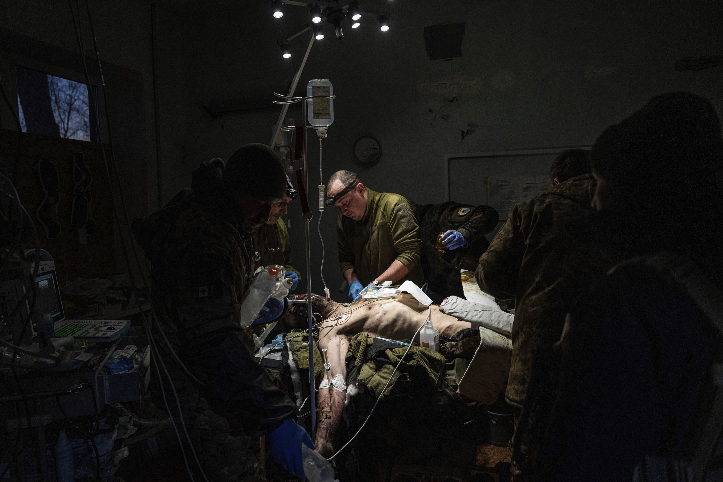  Ukrainian military doctors treat their injured comrade, who was evacuated from the battlefield, at the hospital in Ukraine’s Donetsk region on Jan. 9, 2023. The serviceman did not survive. (AP Photo/Evgeniy Maloletka) 