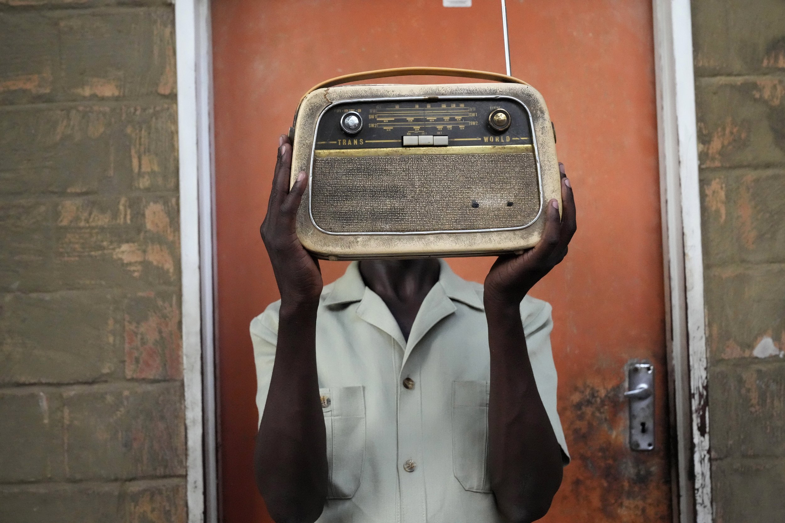  Ngwiza Khumbulani Moyo, a vintage collector, holds an old radio outside his home in Bulawayo, Zimbabwe, on Feb. 15, 2023. (AP Photo/Tsvangirayi Mukwazhi) 