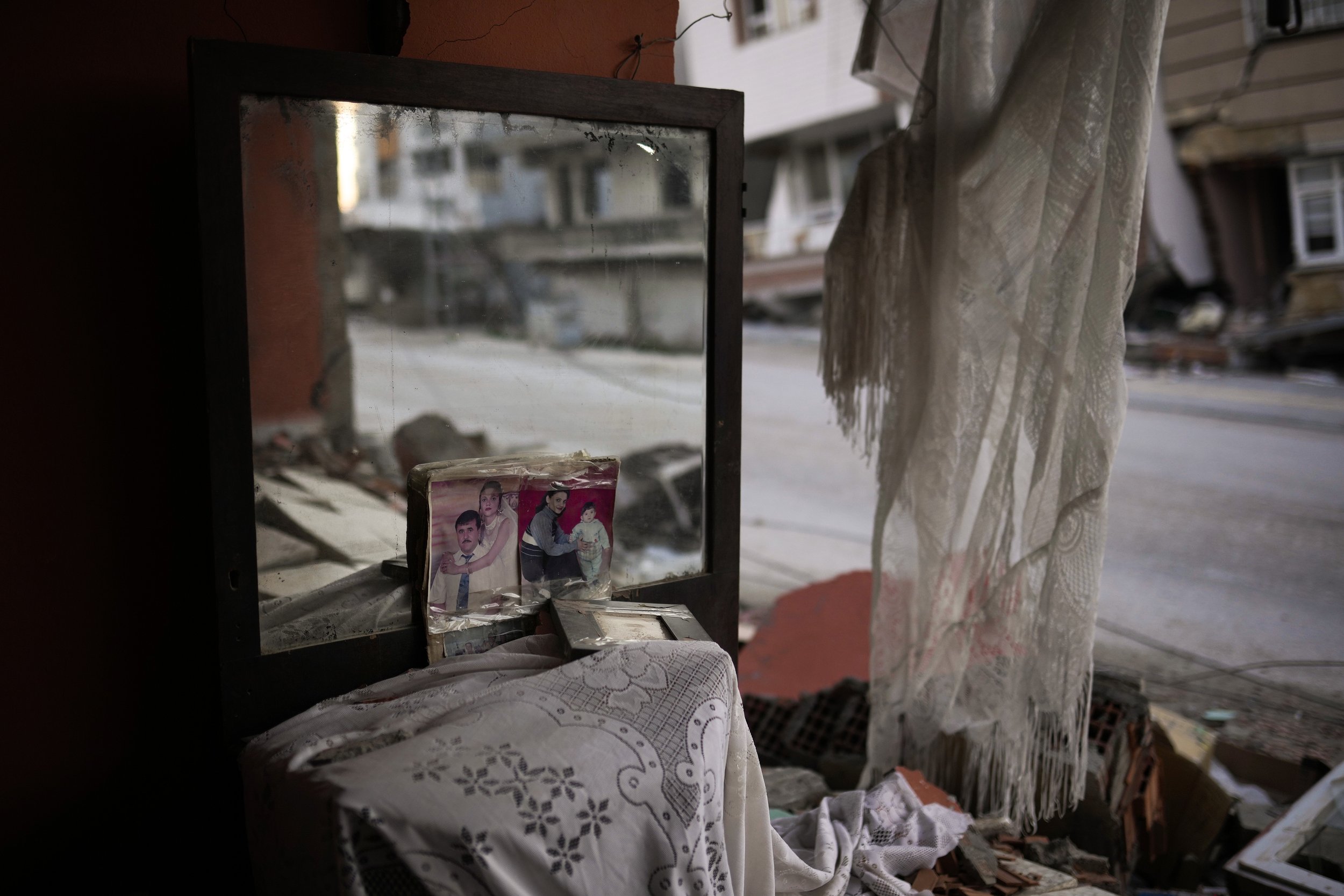  Photographs lie next to a mirror in the room of a destroyed house in Samandag, southern Turkey, on Feb. 16, 2023, after the earthquake struck the area. (AP Photo/Francisco Seco) 