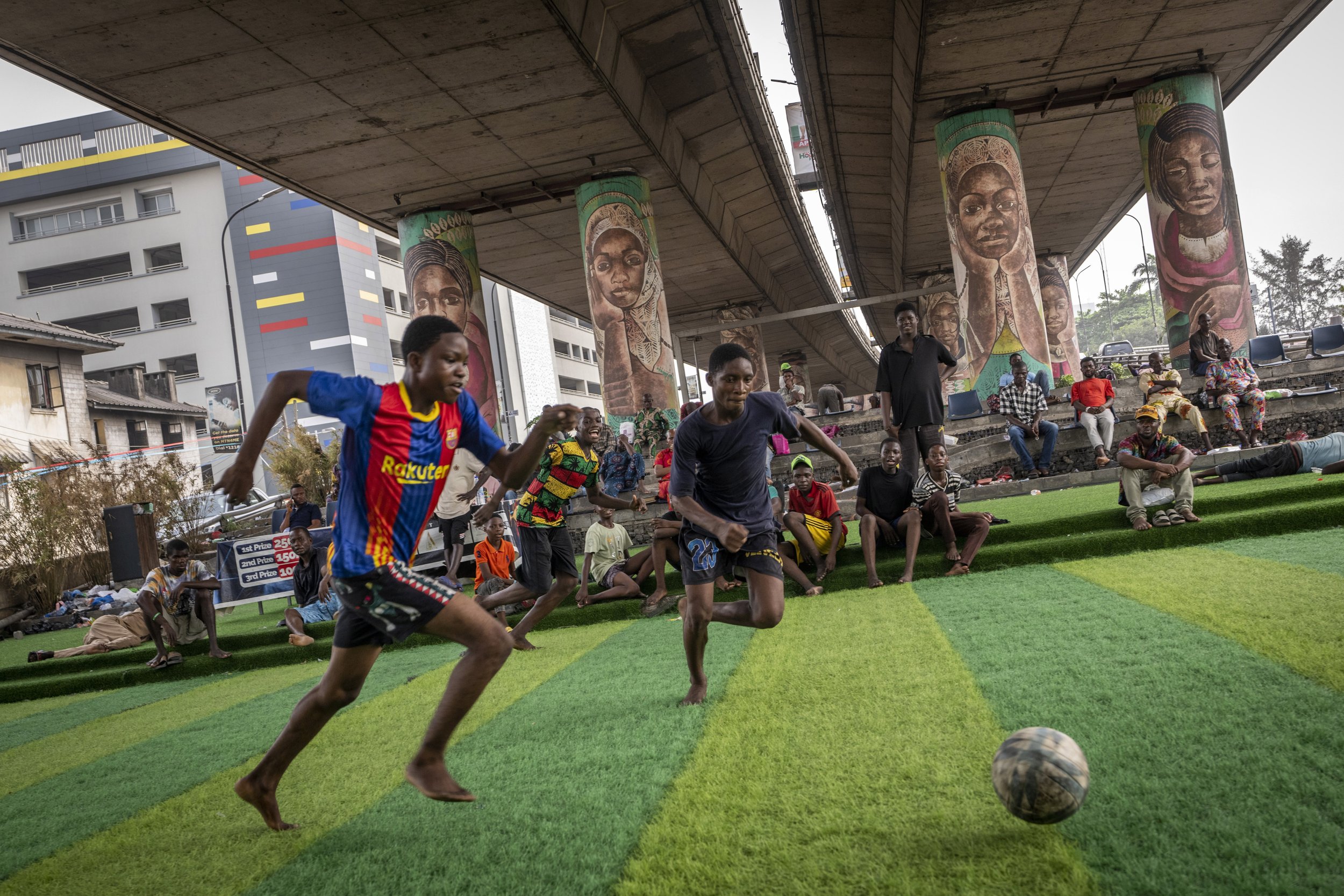  Youth play football underneath a highway overpass on Ikoyi Island, Lagos, Nigeria on Feb. 23, 2023. (AP Photo/Ben Curtis) 