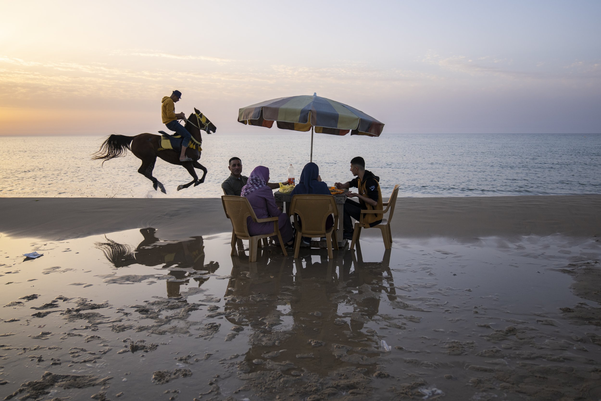  Palestinians enjoy a day on the beach in Gaza City on March 2, 2023. (AP Photo/Fatima Shbair) 
