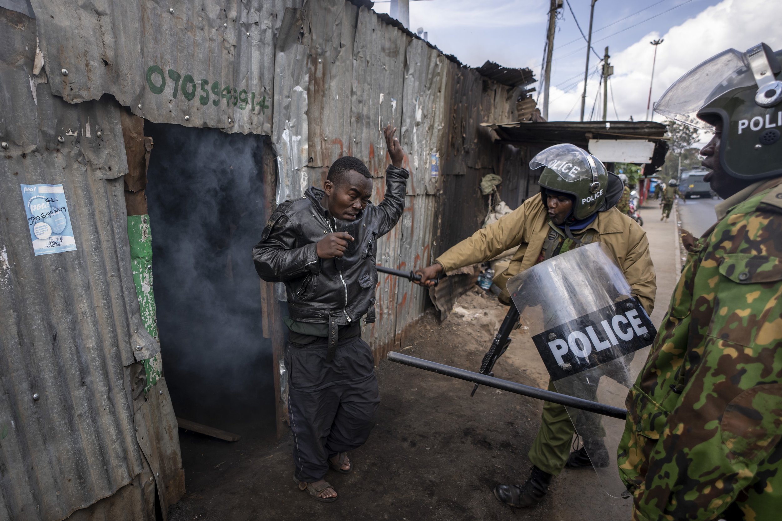  Police beat a protester who had hidden in a shack, after they threw a tear gas grenade inside to force him out, in the Kibera slum of Nairobi, Kenya on March 20, 2023. Hundreds of opposition supporters had taken to the streets of the Kenyan capital 
