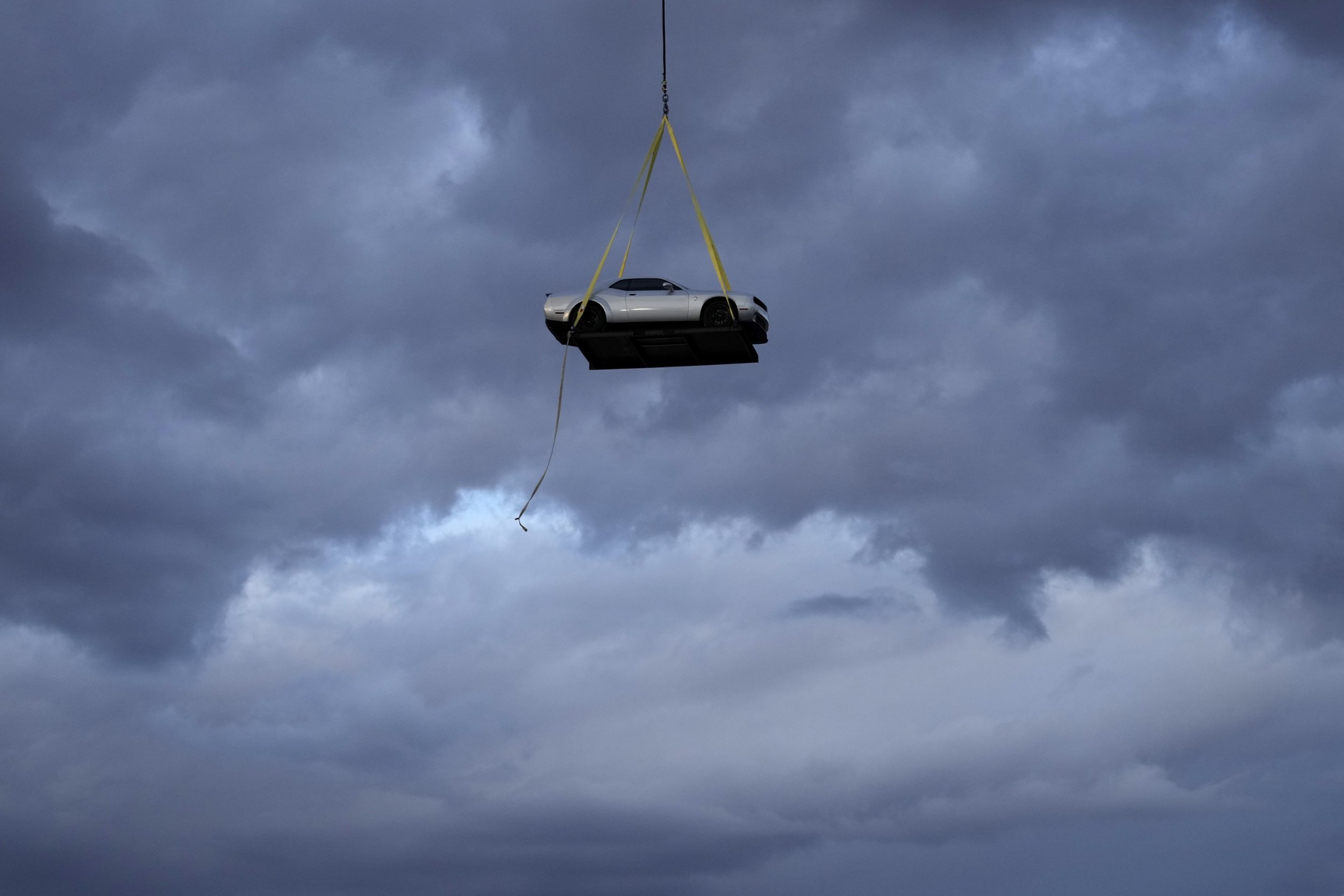  A helicopter transports the 2023 Challenger SRT Demon 170 during an event to unveil the car on March 20, 2023, in Las Vegas. (AP Photo/John Locher) 