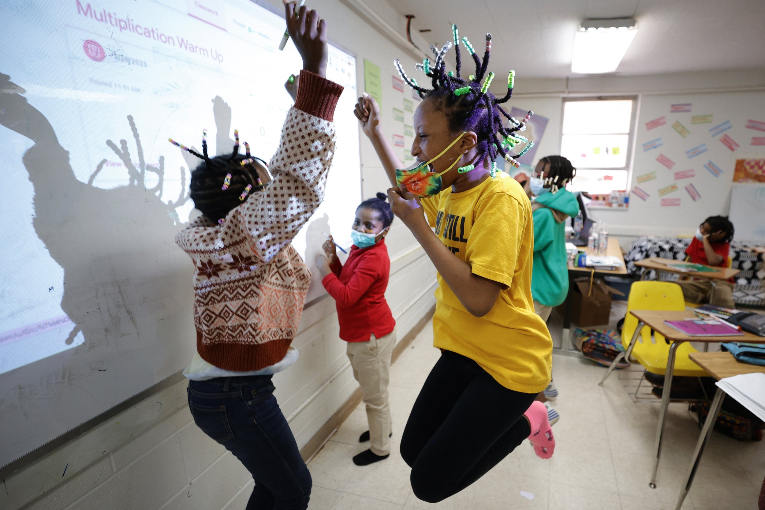  Niambi Cameron, right, celebrates with classmates after answering a question during a math lesson at the Kilombo Academic and Cultural Institute in Decatur, Ga., on March 28, 2023. (AP Photo/Alex Slitz) 