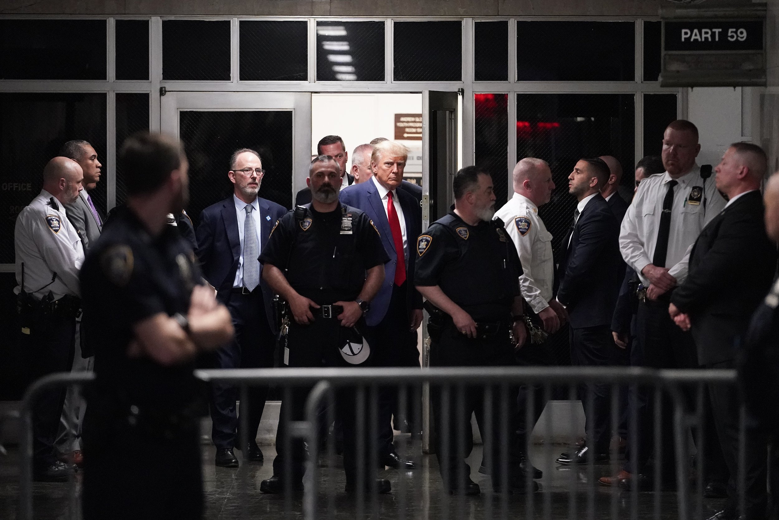  Former President Donald Trump is escorted to a courtroom in New York on April 4, 2023, to appear on charges related to falsifying business records in a hush money investigation. (AP Photo/Mary Altaffer) 