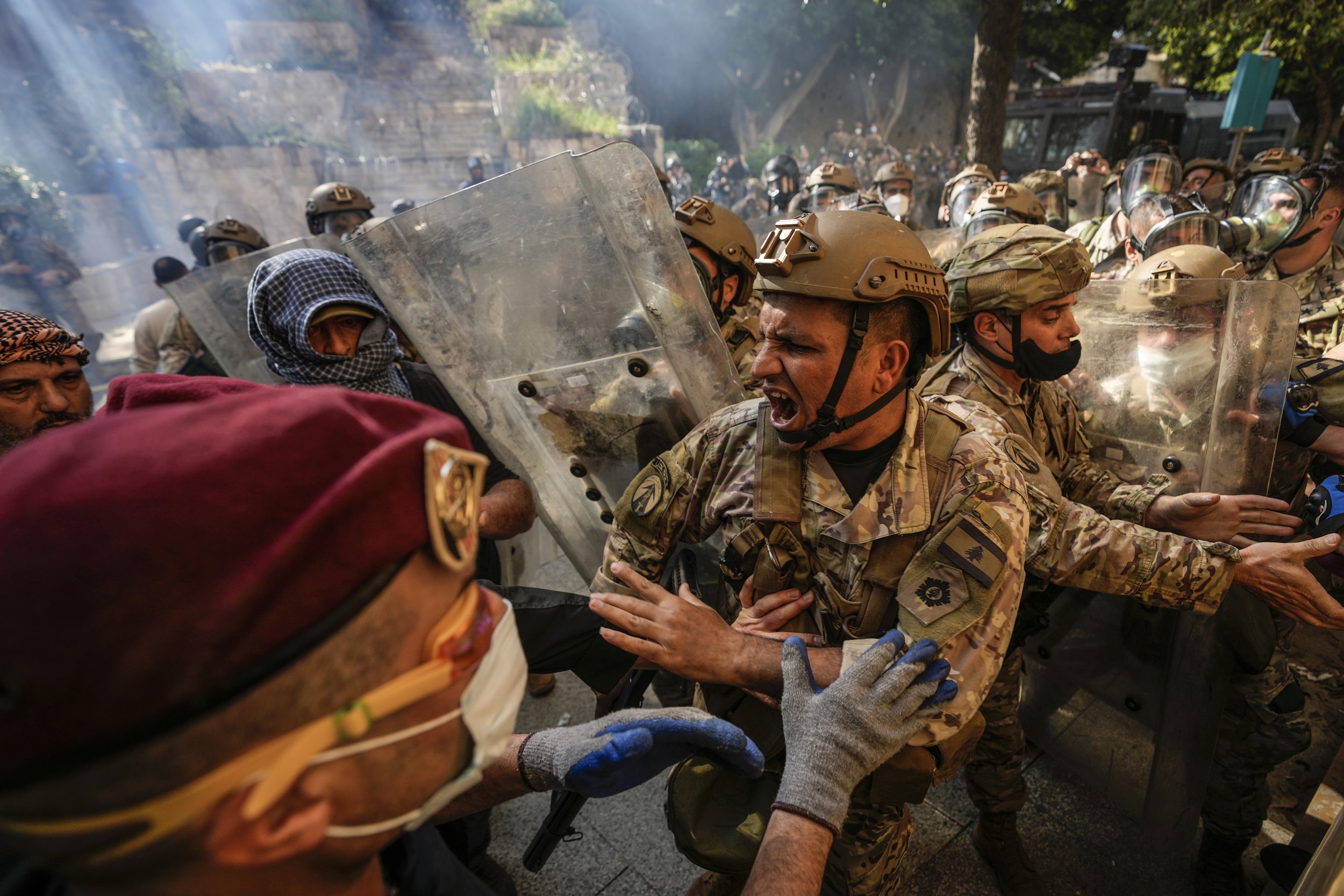  Retired Lebanese security forces and other protesters scuffle with members of the Lebanese army as they try to advance toward government buildings during a protest in Beirut on April 18, 2023. Earlier in the day, Lebanon's Parliament voted to postpo