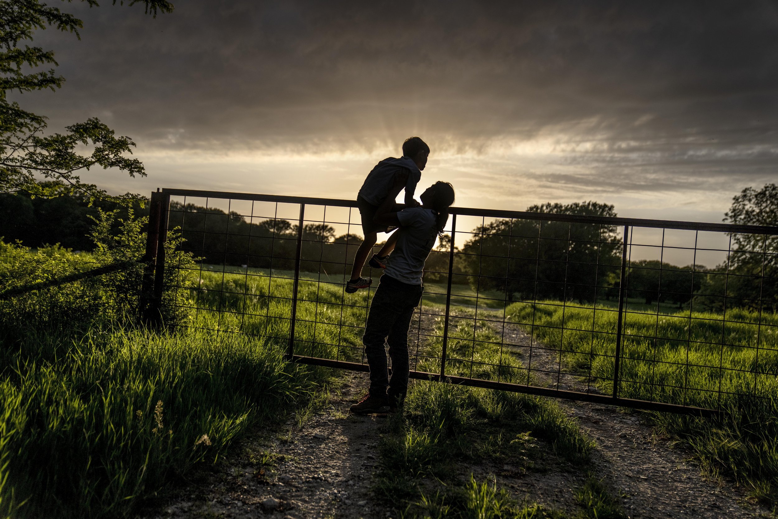  Meredith Ellis looks at cattle in the setting sun with her 6-year-old son, GC, on their ranch in Rosston, Texas, on April 20, 2023. Ellis has seen how global warming is altering her land. She calls it an "existential crisis," the backdrop to the end