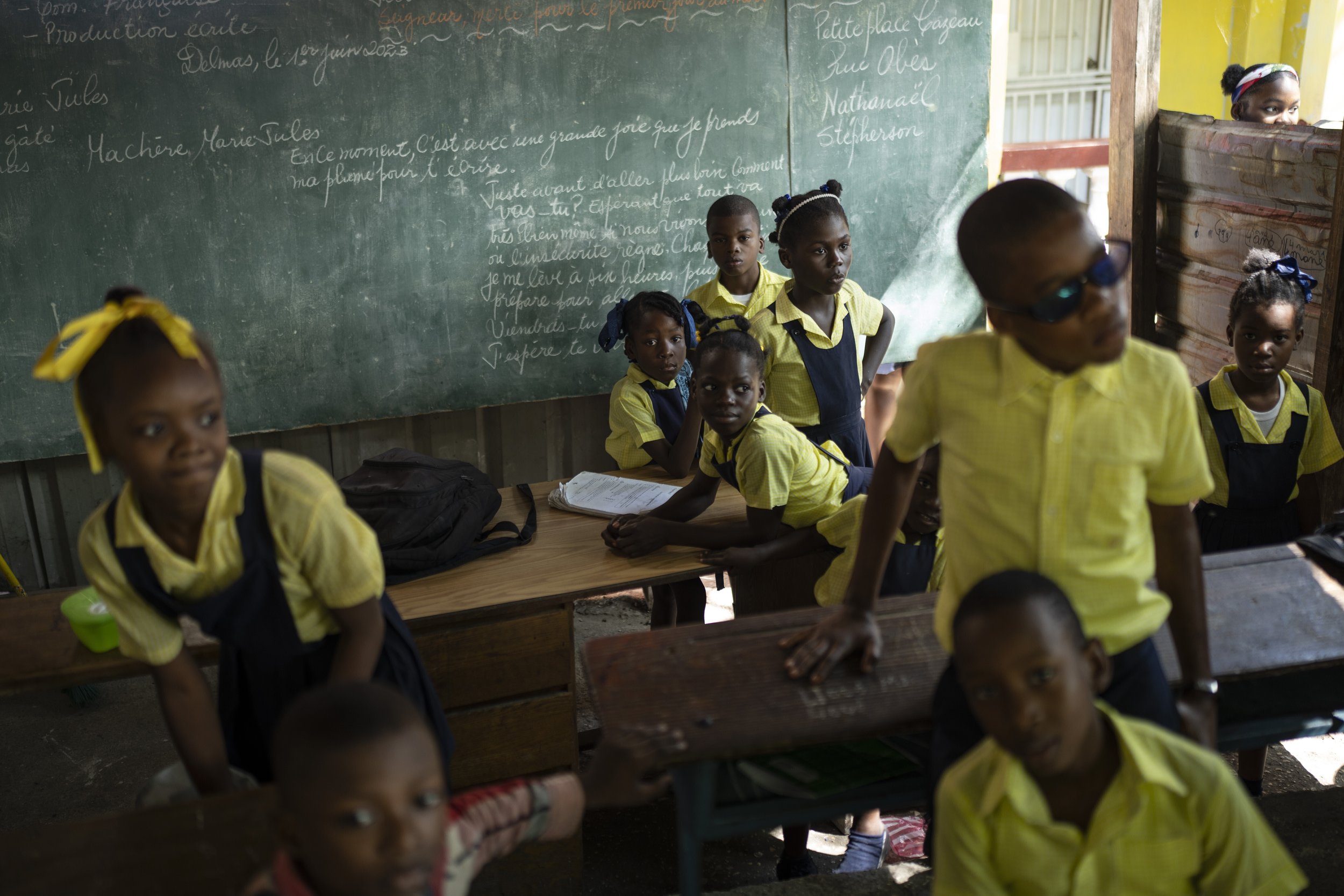  Students wait for their teacher in the classroom at the Institution Mixte Wesleyenne Regard Divin school in Port-au-Prince, Haiti, on June 1, 2023. (AP Photo/Ariana Cubillos) 
