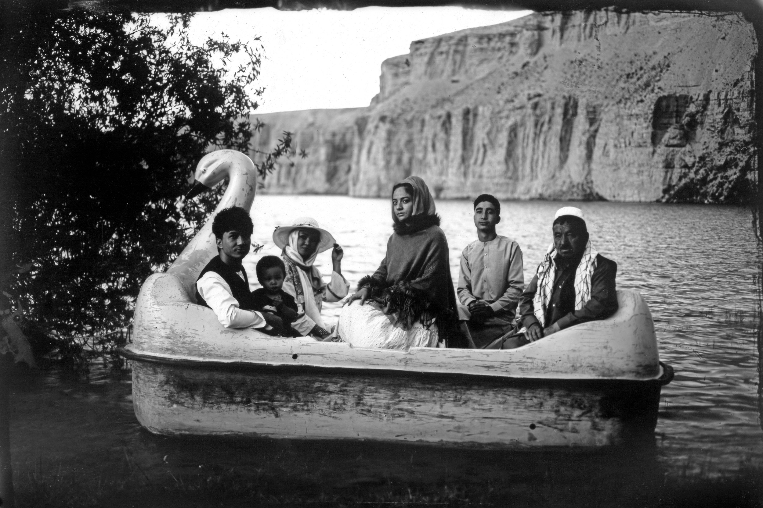 The Moradi family sits for a portrait on a small boat in Band-i-Mir lake, a tourist attraction in the Bamiyan Valley region in Afghanistan, on June 17, 2023. The family traveled there from far away Helmand for their summer vacation. This image was t