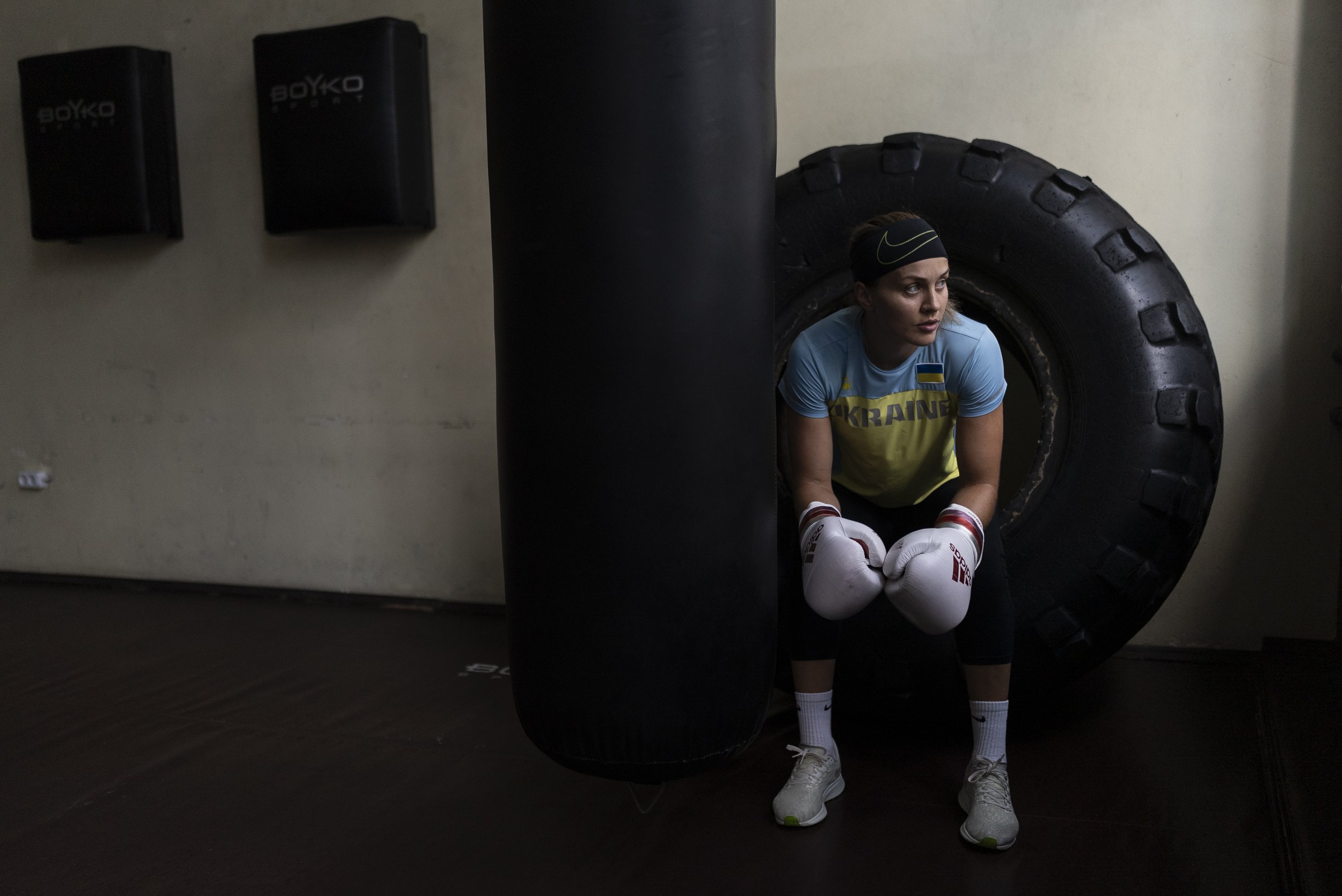  Ukrainian boxer Anna Lysenko sits on a tire during a short break in her training at Kiko Boxing Club in Kyiv, Ukraine, on July 11, 2023. Lysenko dedicates long hours preparing for next year's Paris Olympics, despite the unsettling sounds of explosio