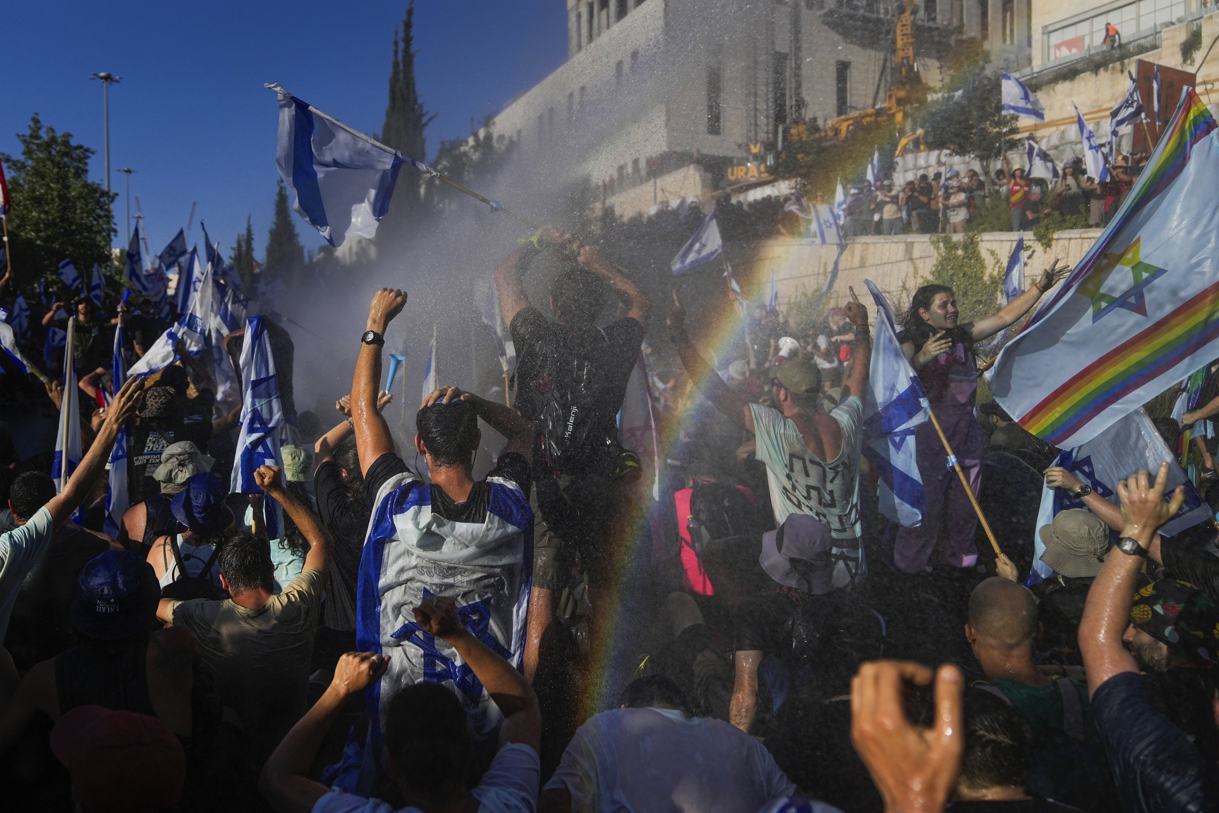  Israeli police use a water cannon to disperse demonstrators blocking a road in Jerusalem, during a protest against plans by Prime Minister Benjamin Netanyahu's government to overhaul the judicial system on July 24, 2023. (AP Photo/Ohad Zwigenberg) 