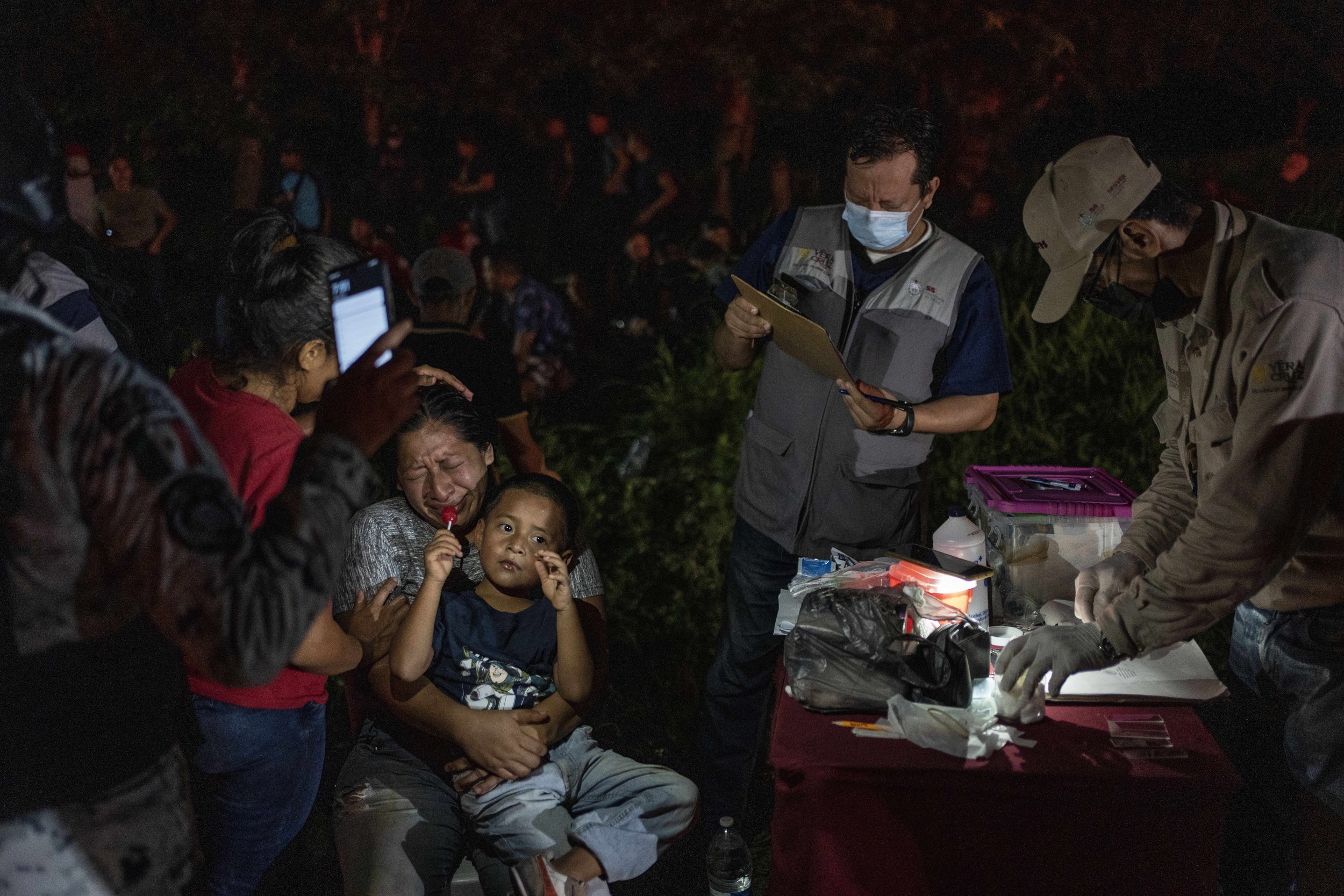  Migrants, mainly from Central America, who were traveling to the United States inside a tractor-trailer, are detained by Mexican immigration agents and National Guard members, in Veracruz, Mexico, on July 23, 2023. (AP Photo/Felix Marquez) 