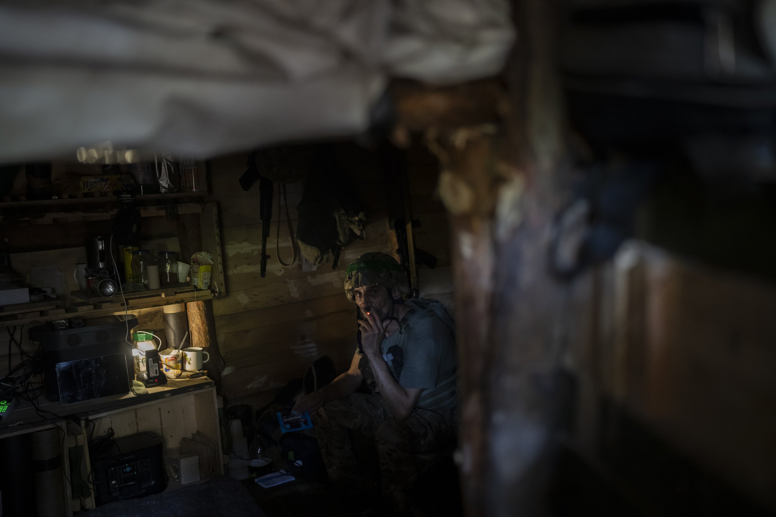  A Ukrainian soldier sits inside a trench on the frontline in the outskirts of Kreminna, Ukraine, on Aug. 16, 2023. (AP Photo/Bram Janssen) 