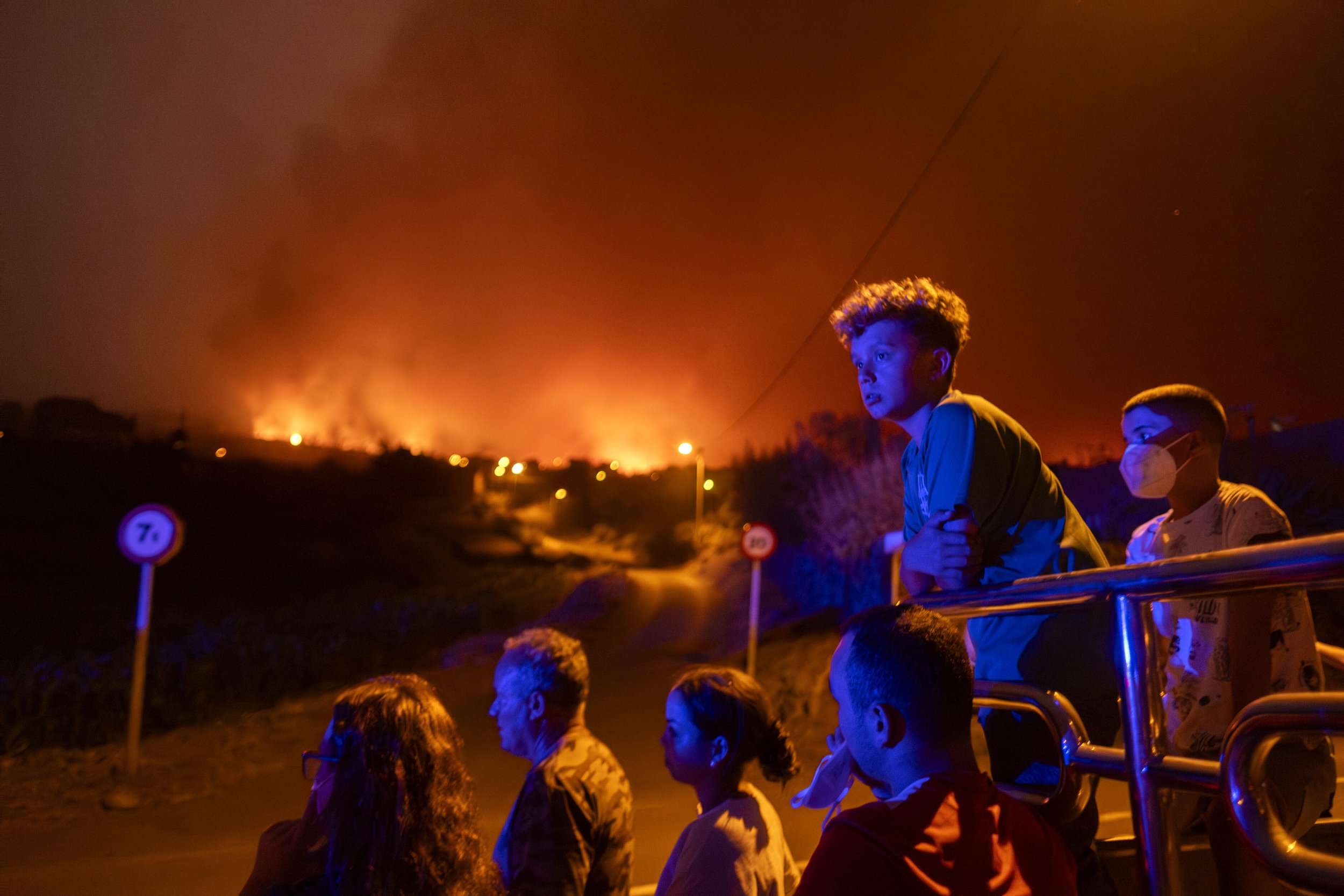  Residents are blocked by police as they try to reach their houses in Benijos village as a wildfire advances in La Orotava in Tenerife, Canary Islands, Spain on Aug. 19, 2023. (AP Photo/Arturo Rodriguez) 