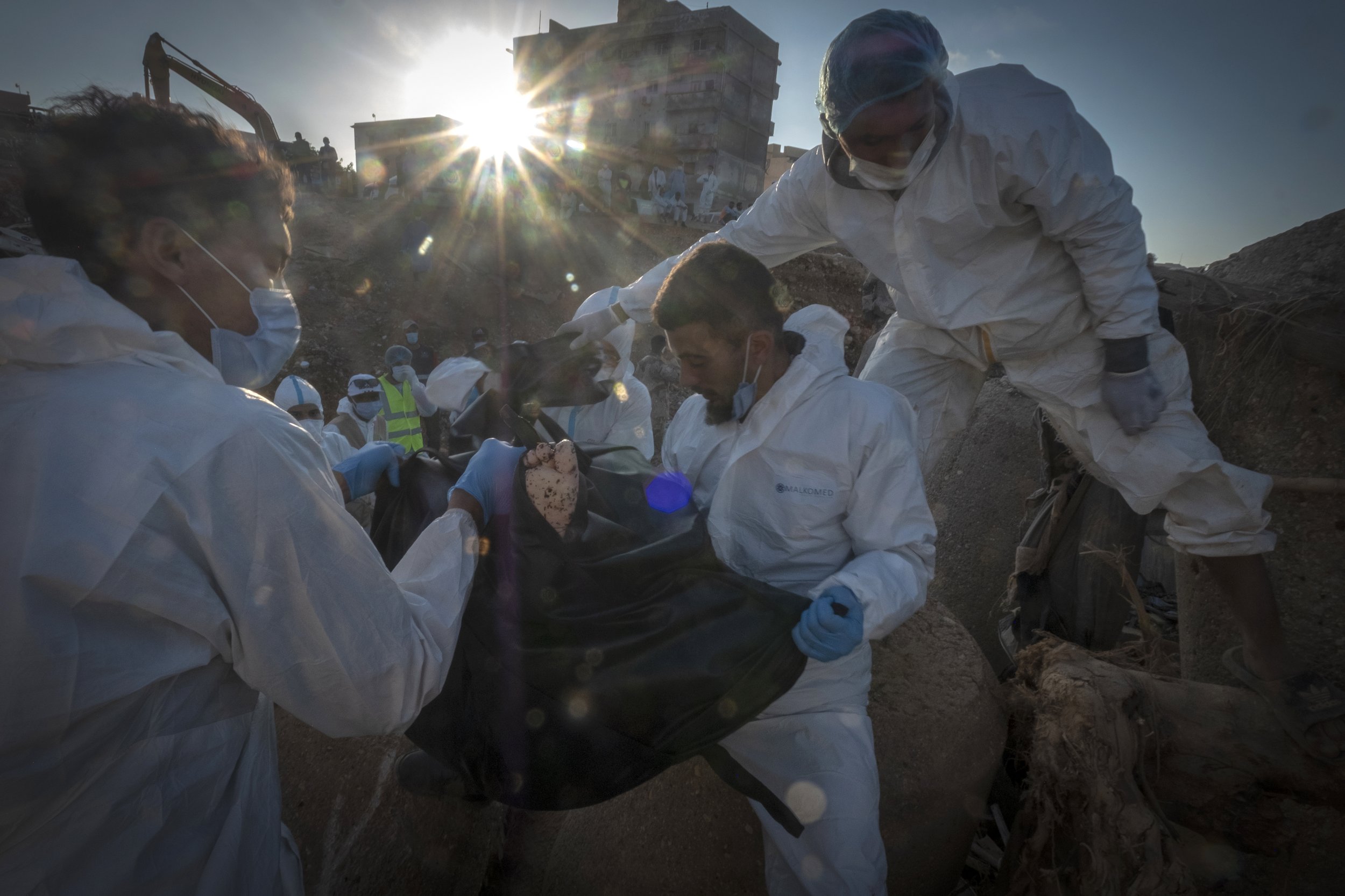  Rescuers recover the body of a victim killed during flooding in Derna, Libya, on Sept. 15, 2023. The collapse of two dams unleashed a massive flash flood that killed thousands of people in Derna. (AP Photo/Ricardo Garcia Vilanova) 