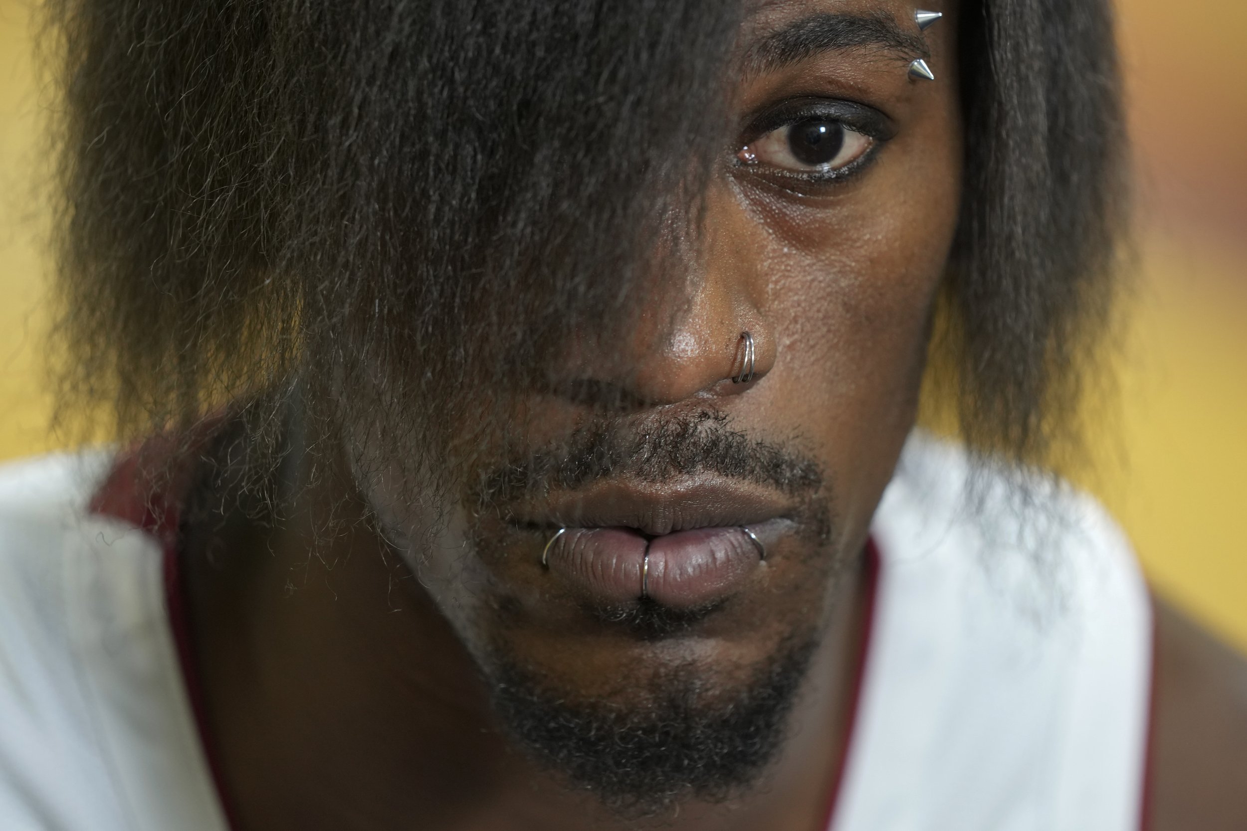  Miami Heat forward Jimmy Butler, sporting a new hairdo and piercings, listens during an interview as part of the NBA basketball team's media day in Miami on Oct. 2, 2023. (AP Photo/Rebecca Blackwell) 