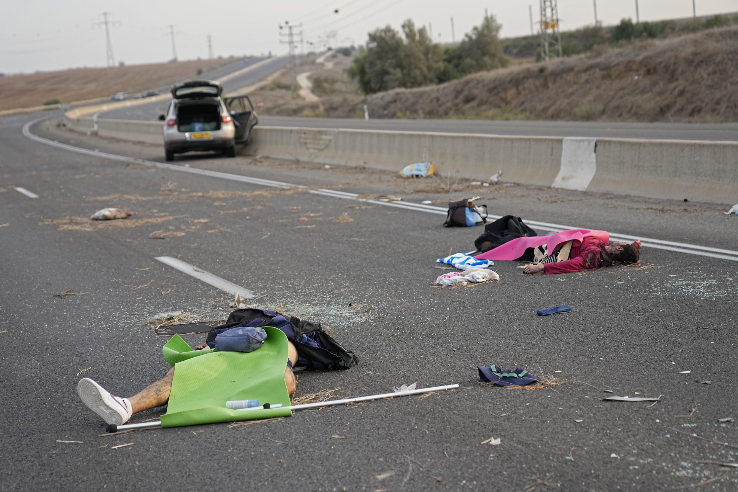  Israelis killed by Hamas militants lie on the road near Sderot, Israel, on Oct. 7, 2023. Palestinian militants from the Gaza Strip infiltrated southern Israel Saturday and fired thousands of rockets into the country, prompting Israel to begin striki