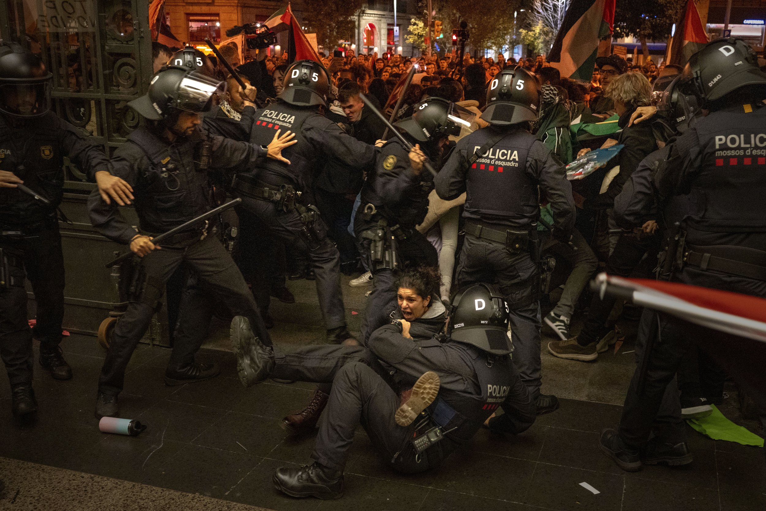  Police officers clash with pro-Palestinian demonstrators trying to enter a train station in Barcelona, Spain, on Nov. 11, 2023. Thousands of protesters had earlier taken part in a march against Israel's response in Gaza to a deadly attack by Hamas o