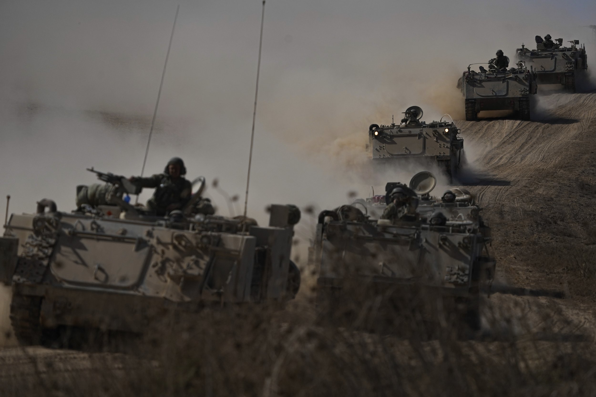  Israeli armored personel carriers head toward the Gaza Strip border in southern Israel on Oct.13, 2023. (AP Photo/Ariel Schalit) 