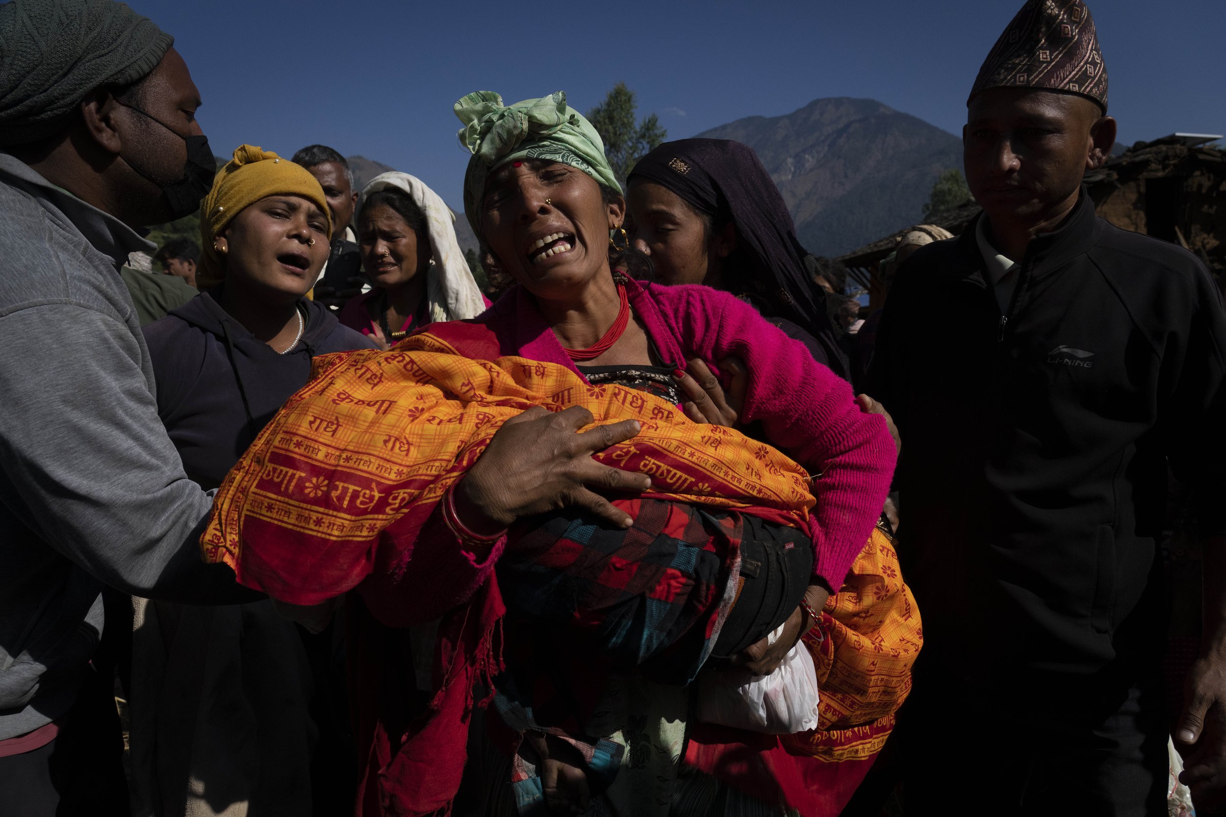  A woman holds the lifeless body of her grandchild, killed in an earthquake two days earlier, in Jajarkot district, northwestern Nepal, on Nov. 5, 2023. (AP Photo/Niranjan Shrestha) 