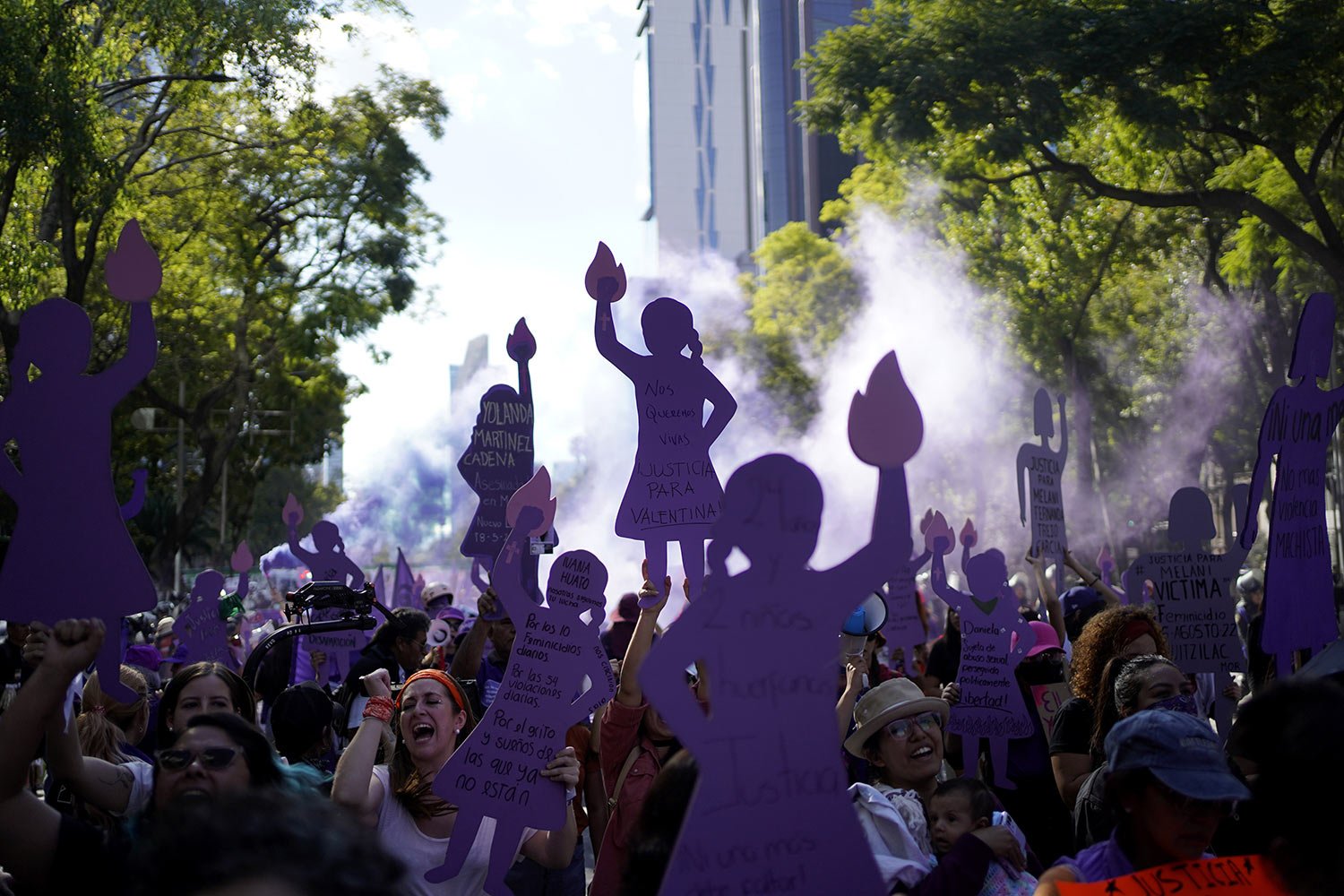 Women, many holding up purple silhouette cutouts that depict the anti-monument "Mujeres que luchan" or women who fight, march to the Zocalo to mark International Day for the Elimination of Violence against Women, in Mexico City, Nov. 25, 2023. (AP P