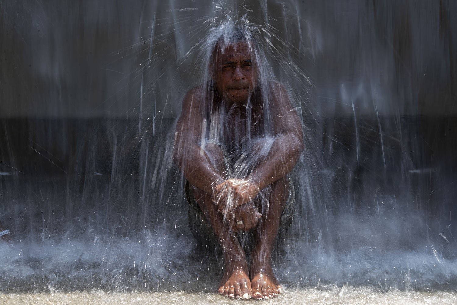  A man cools off in a water fountain at Madureira Park amid a heat wave in Rio de Janeiro, Brazil, Nov. 15, 2023. (AP Photo/Bruna Prado) 