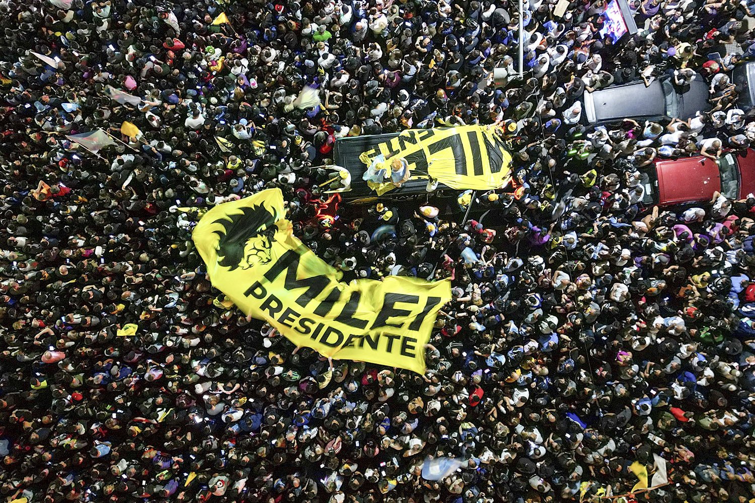  Supporters of presidential candidate Javier Milei gather outside his campaign headquarters after his opponent conceded defeat in the presidential runoff election, in Buenos Aires, Argentina, Nov. 19, 2023. (AP Photo/Matias Delacroix) 