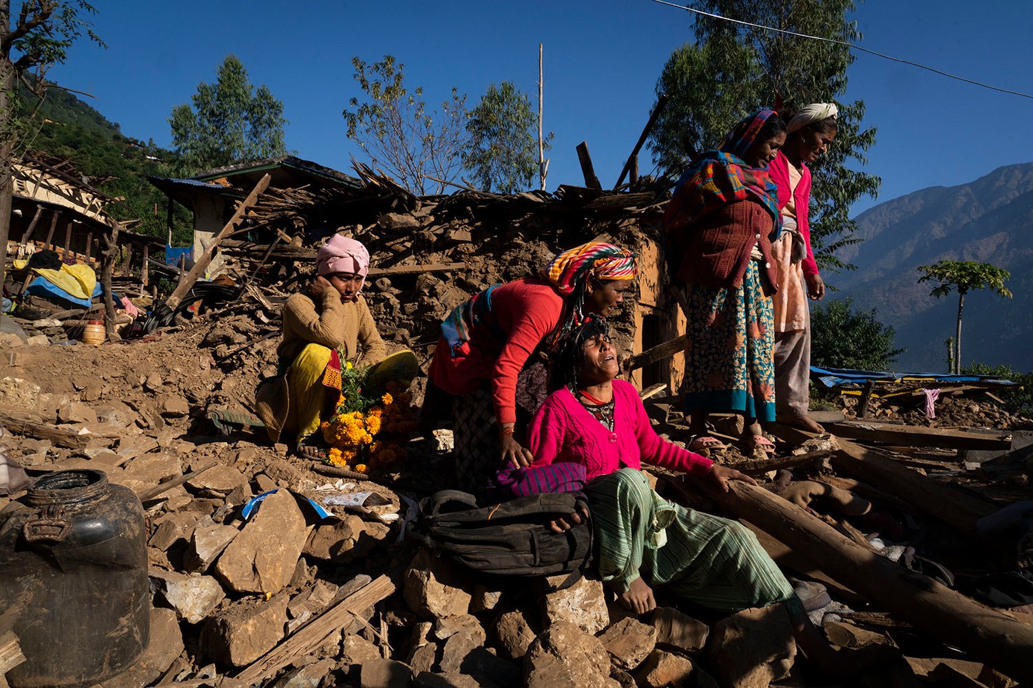  A woman cries near the earthquake-damaged house where her son, daughter-in-law and grandchild died in  Jajarkot district, northwestern Nepal, Sunday, Nov. 5, 2023. (AP Photo/Niranjan Shrestha) 