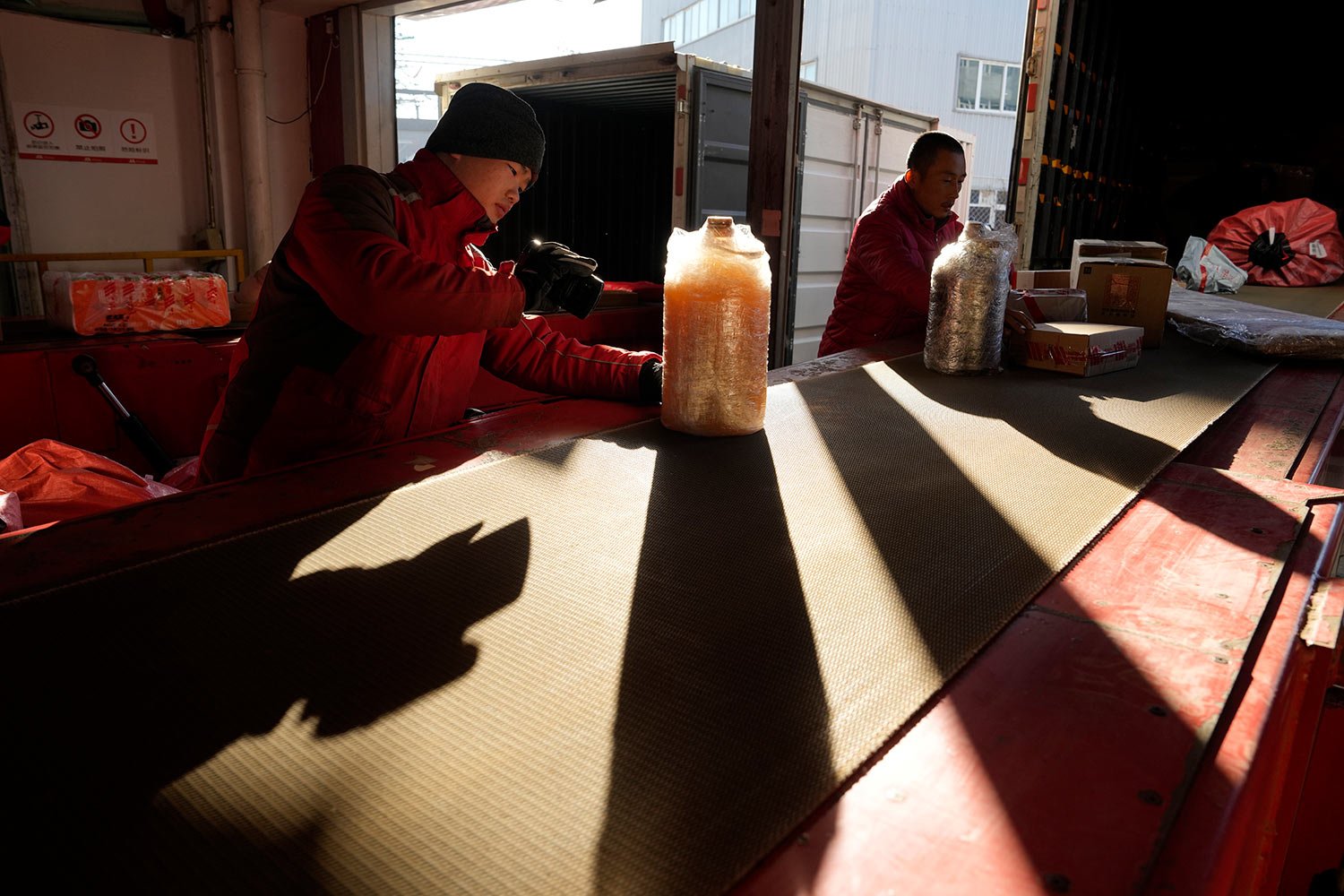  Workers sort out parcels at a distribution center for e-commerce platform JD.com in Beijing, Saturday, Nov. 11, 2023.  (AP Photo/Ng Han Guan) 