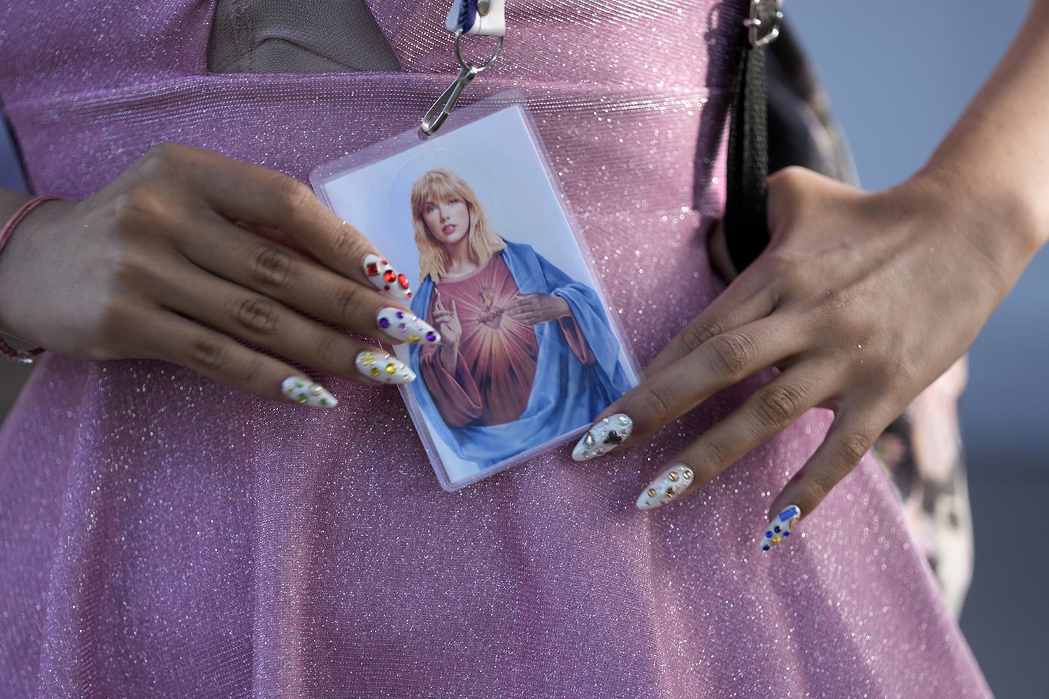  A fan holds a prayer-like card simulating Taylor Swift as the Most Sacred Heart of Jesus, before the start of The Eras Tour concert at the Monumental stadium in Buenos Aires, Argentina, Nov. 9, 2023. Thousands of "Swifties" attended the superstar’s 