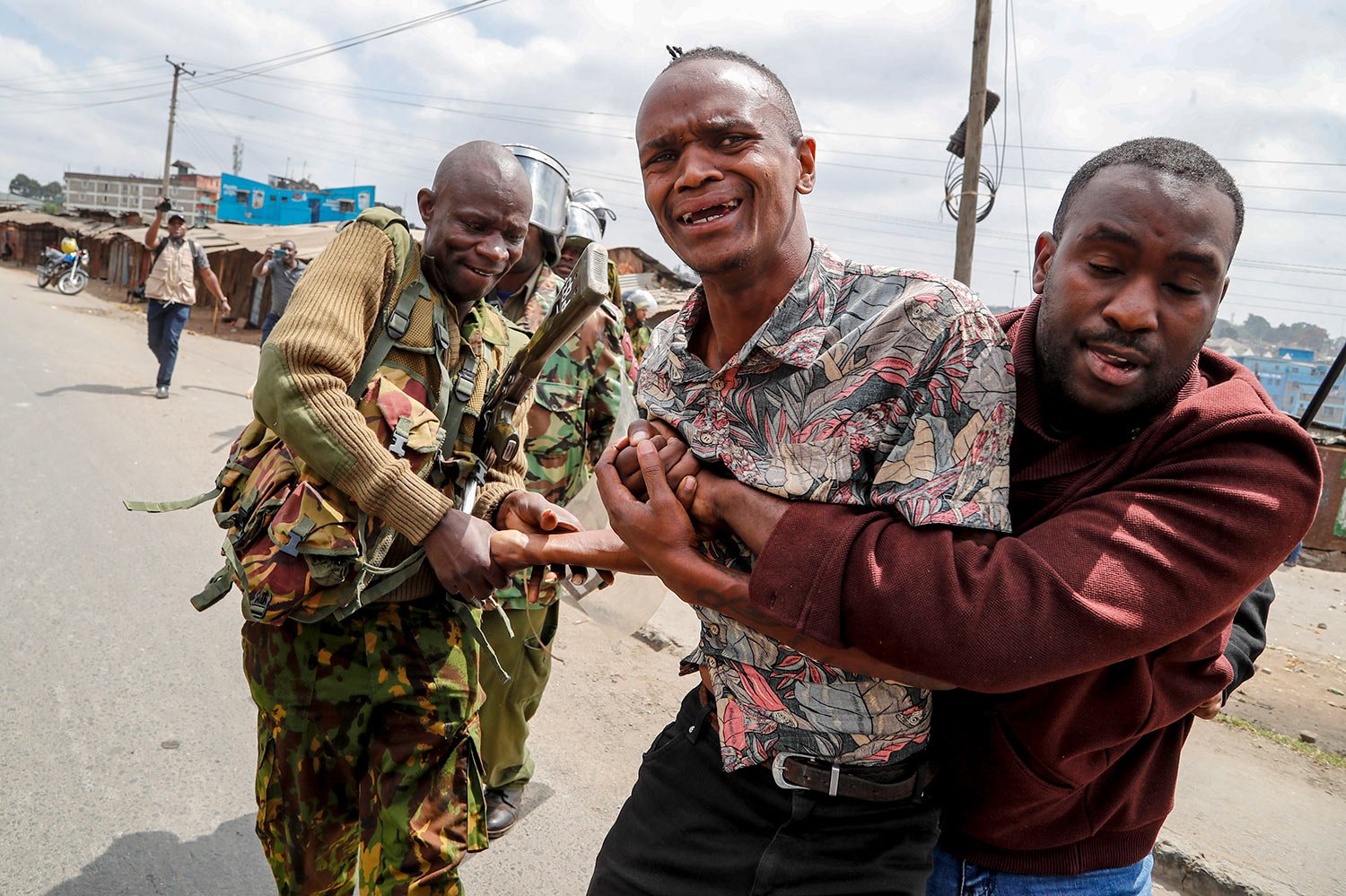  Police arrest a protester rallying against newly imposed taxes and the increased cost of living during clashes in the Mathare area of Nairobi, Kenya Wednesday, July 19, 2023. (AP Photo/Brian Inganga) 
