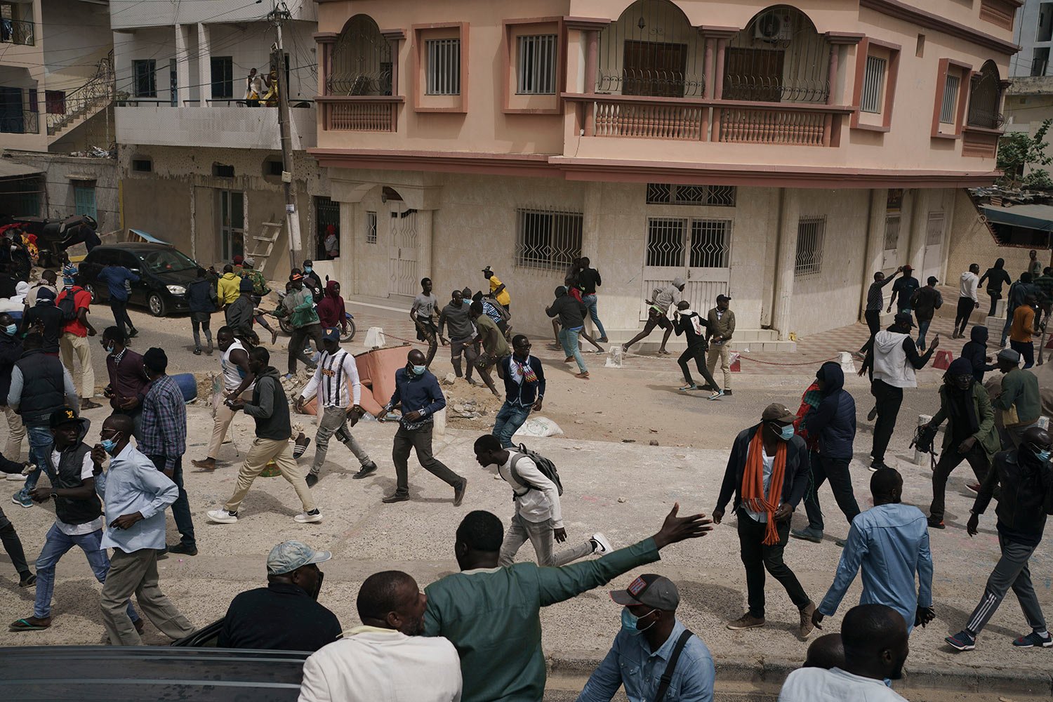  People run from tear gas thrown by riot police after the opposition leader Ousmane Sonko left the tribunal in Dakar, Senegal, Thursday, Feb. 16, 2023.  (AP Photo/Leo Correa) 