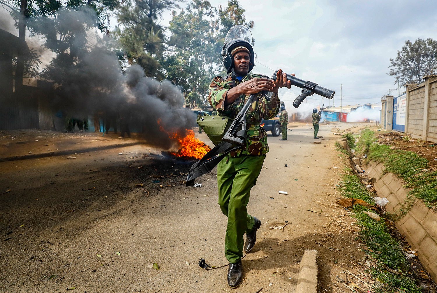  A riot policeman reloads a teargas grenade launcher during clashes with protesters in the Kibera area of Nairobi, Kenya, July 19, 2023.  (AP Photo/Brian Inganga,) 