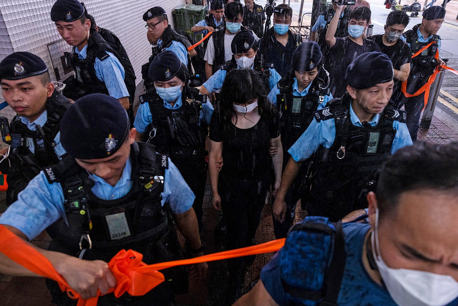  Police officers take away a member of the public in the Causeway Bay area on the eve 34th anniversary of China's Tiananmen Square massacre in Hong Kong, Saturday, June 3, 2023. (AP Photo/Louise Delmotte) 