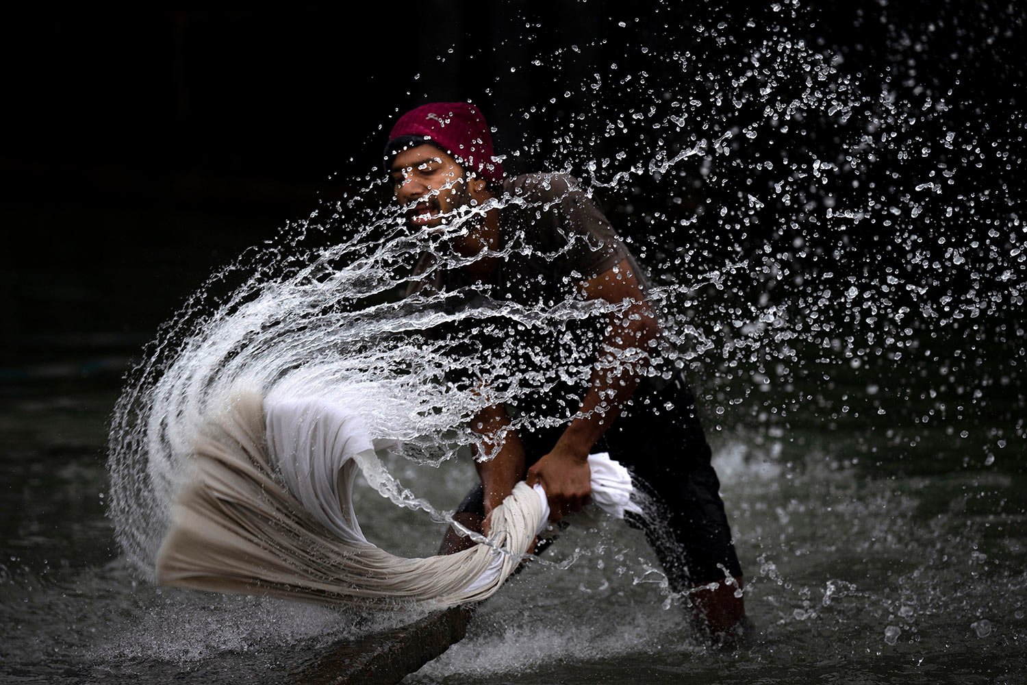  A washerman washes clothes on the banks of the river Brahmaputra on World Water Day in Guwahati, India, Wednesday, March 22, 2023. (AP Photo/Anupam Nath) 