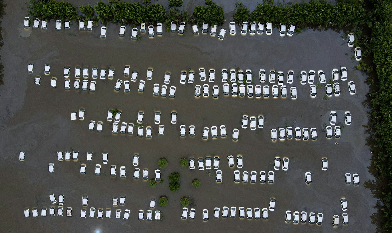  A private car warehouse is submerged in water from River Hindon following excessive rains, in Greater Noida, out skirts of New Delhi, India, Wednesday, July 26, 2023. (AP Photo/Piyush Nagpal) 