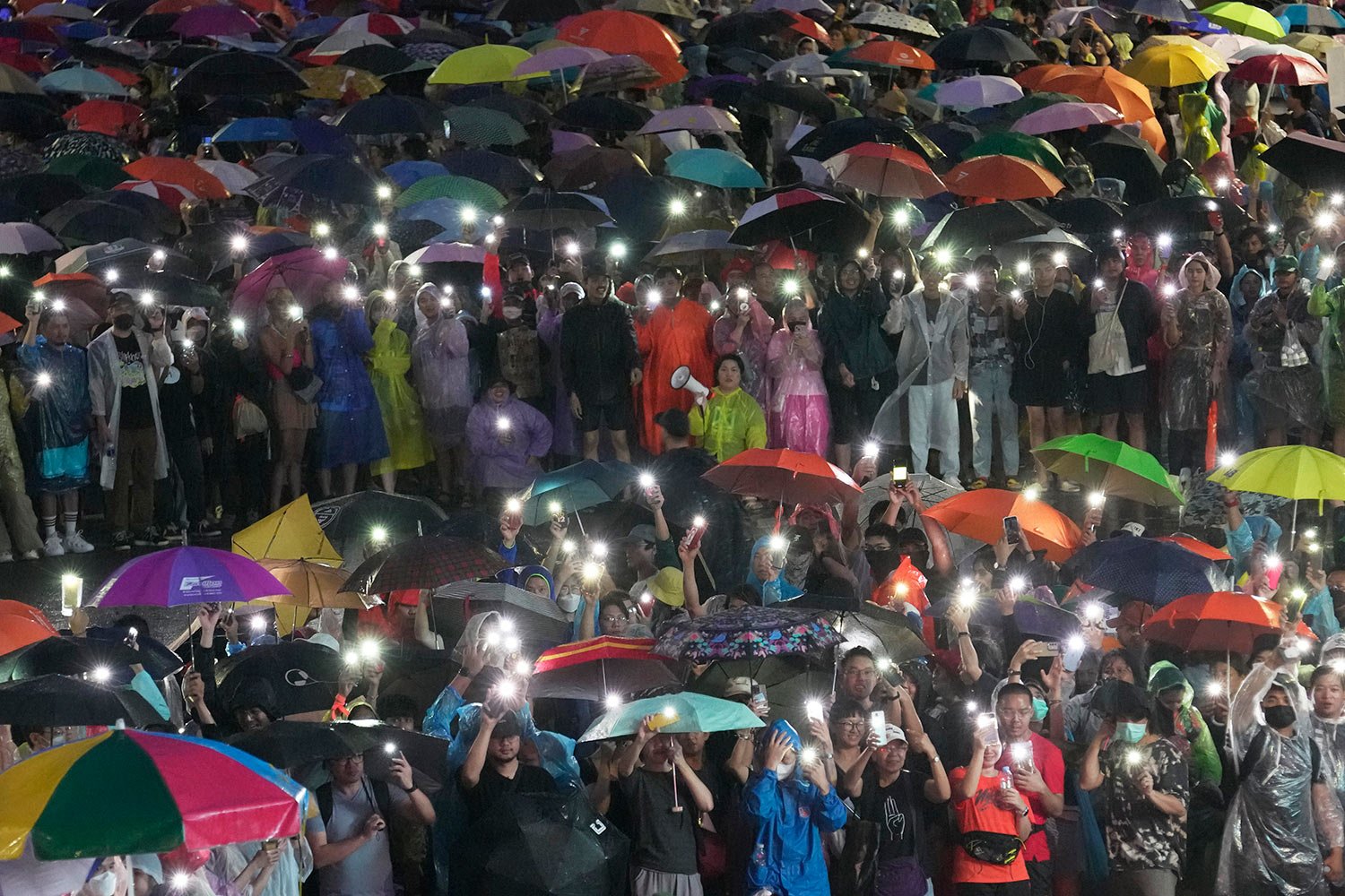  Supporters of the Move Forward Party display mobile phones with flashlights on during a protest in Bangkok, Thailand, Sunday, July 23, 2023.  (AP Photo/Sakchai Lalit) 